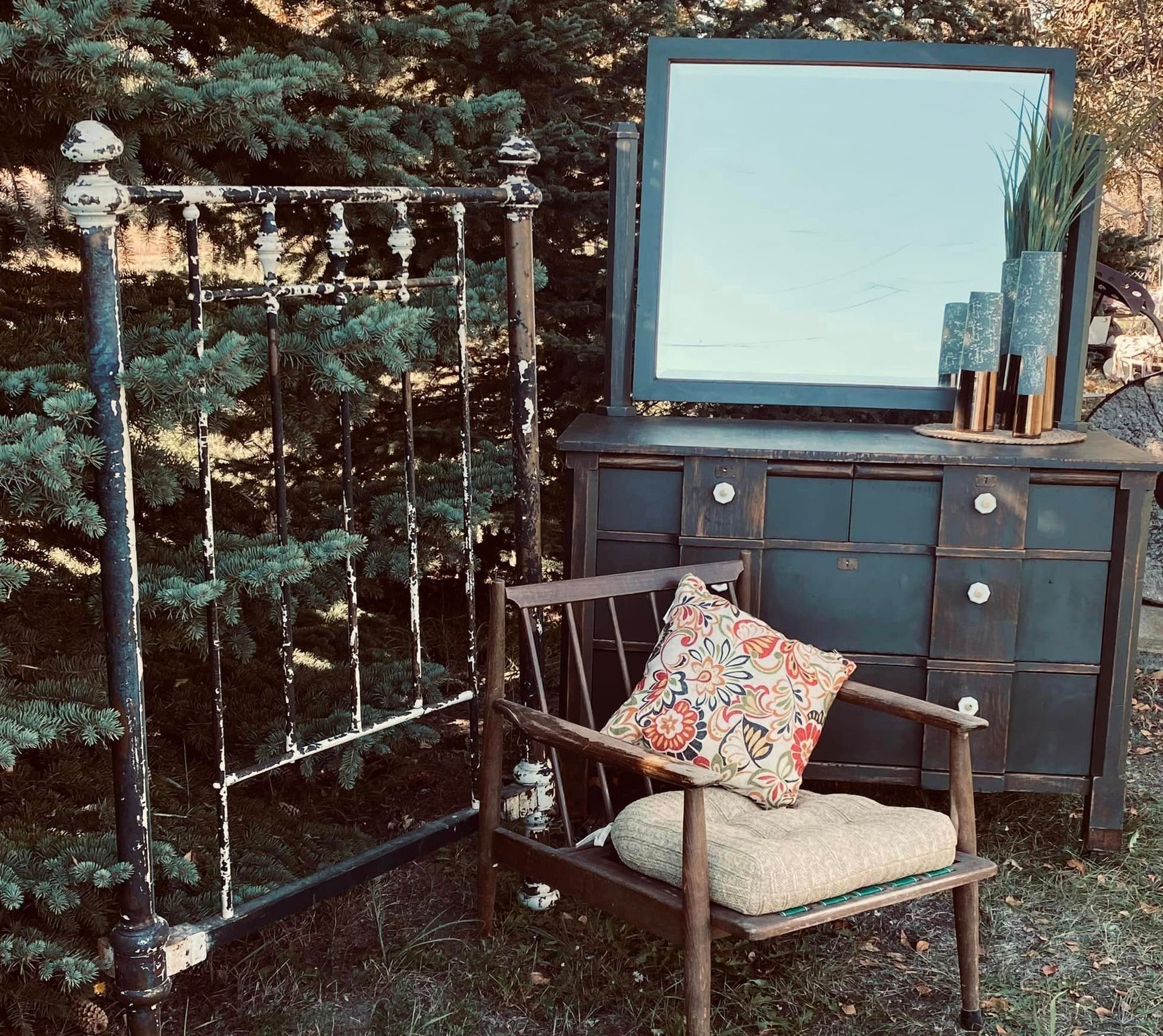 vintage dresser and chair next to pine tree
