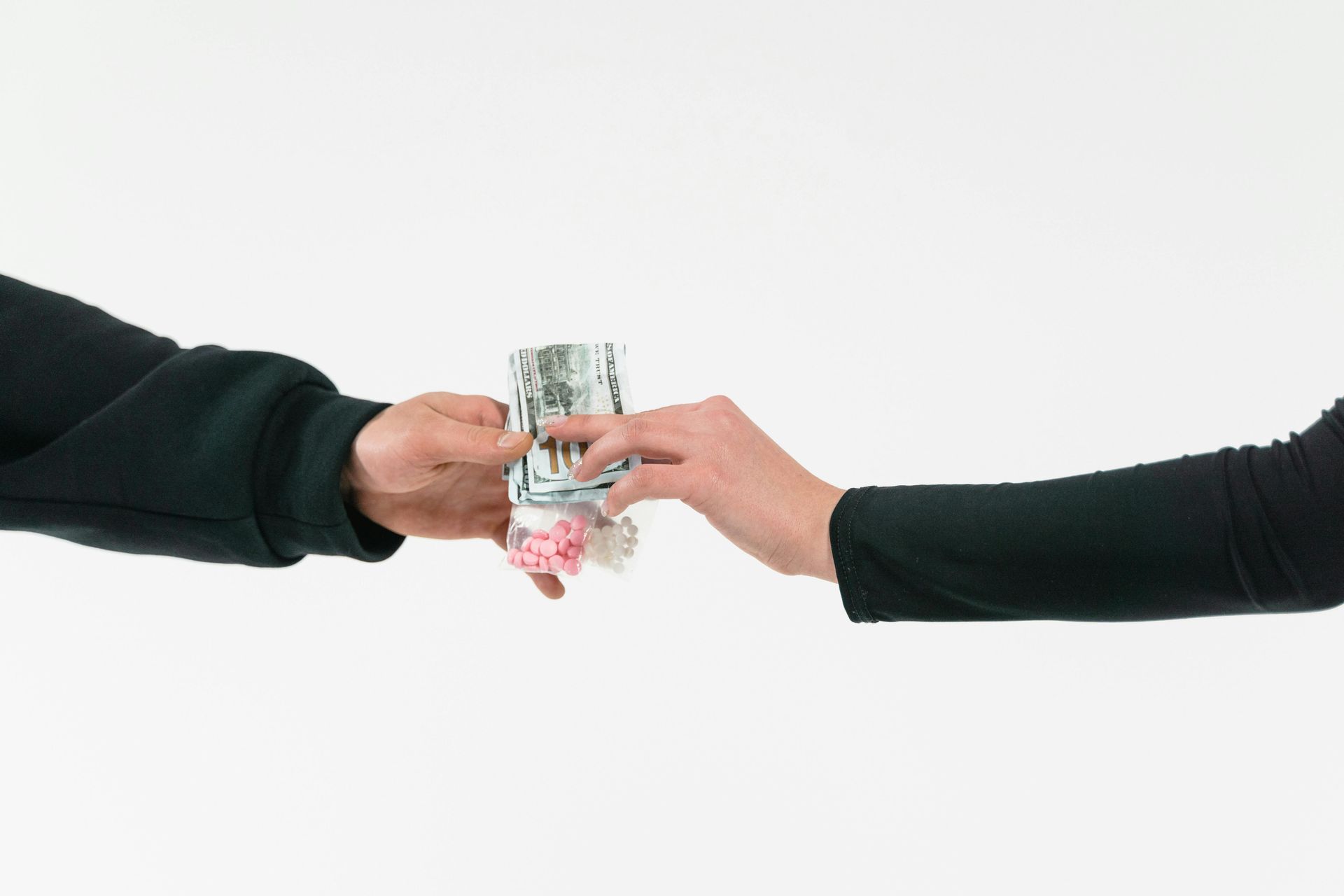 Hands exchanging money and small items. Working to benefit each other.