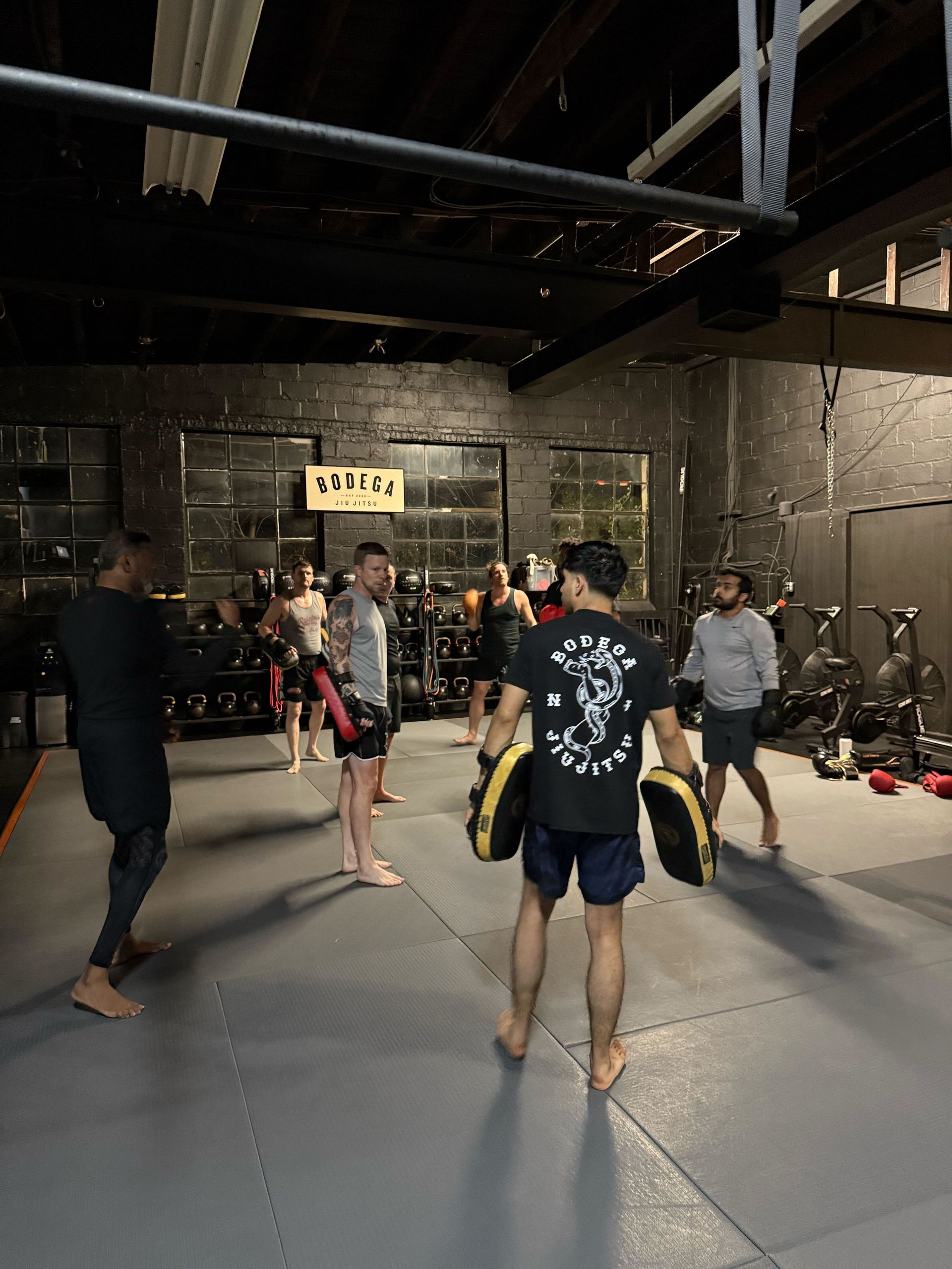 Adult students practicing grappling escapes at Bodega Jiu-Jitsu in Maplewood, NJ for practical self-defense.
