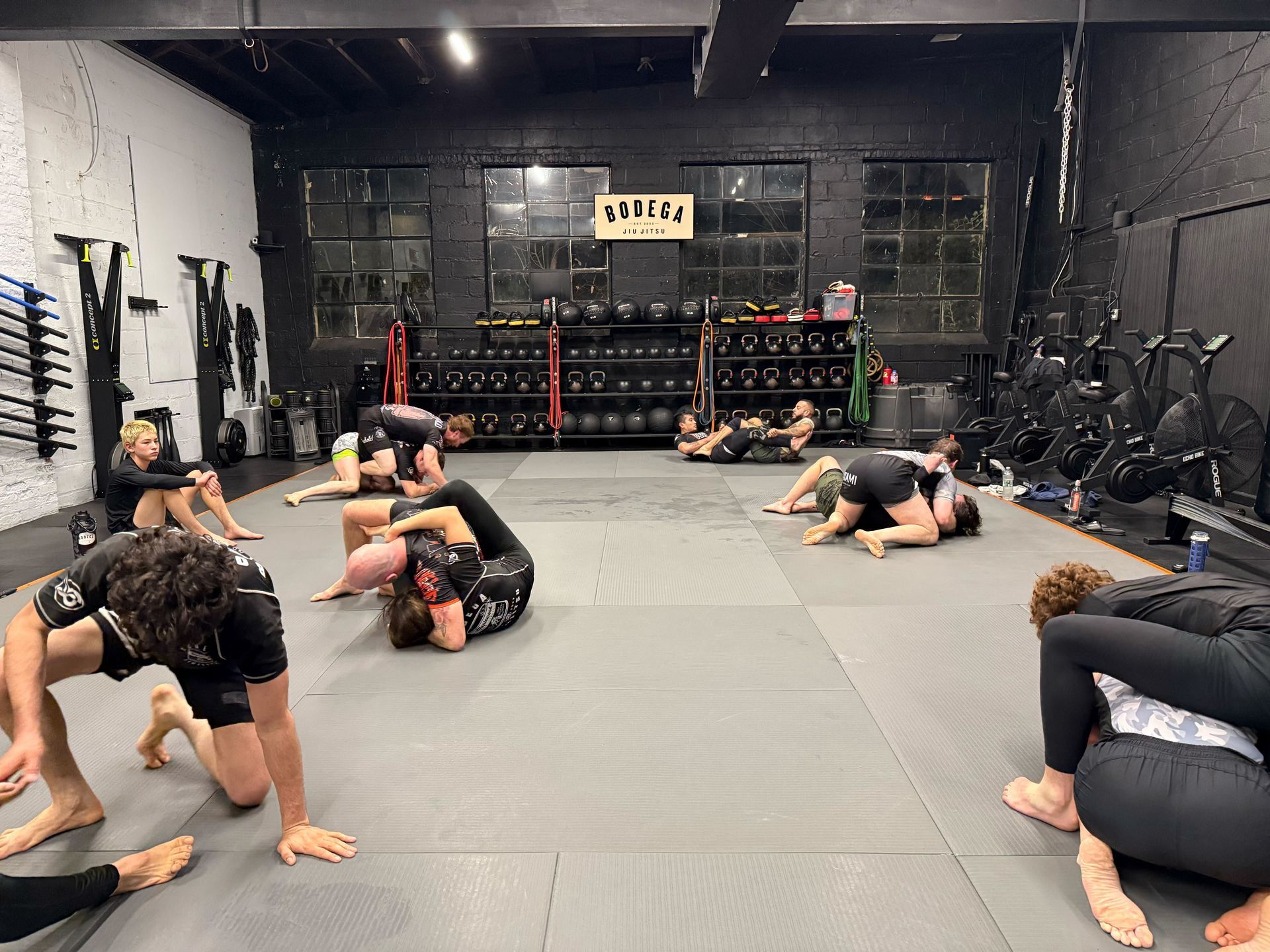 Adult students training grappling drills at Bodega Jiu-Jitsu in Maplewood, NJ for full-body fitness.