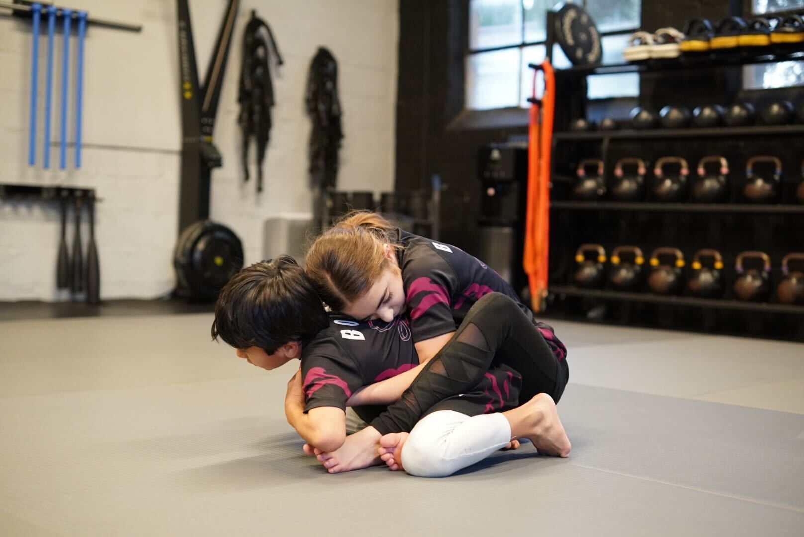 Kids practicing controlled grappling in a Youth Jiu-Jitsu class at Bodega Jiu-Jitsu in Maplewood, NJ, building resilience.