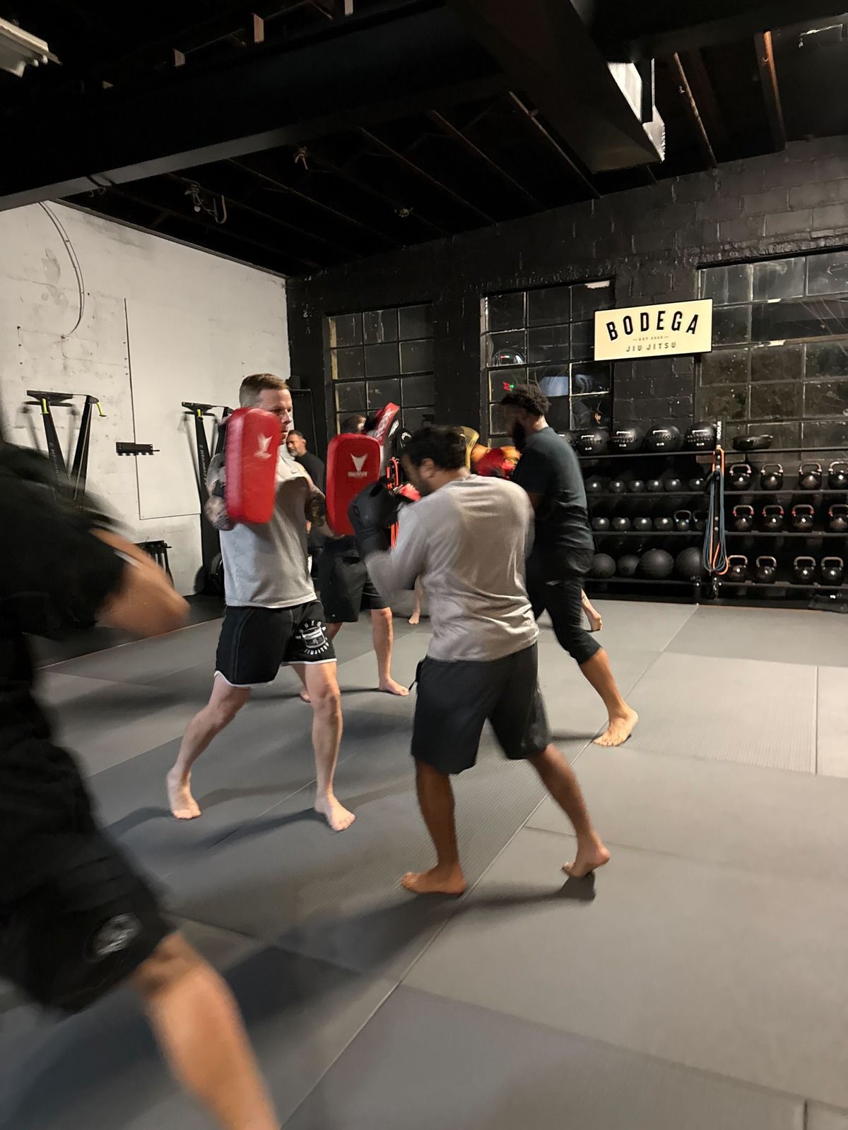 Adults practicing grappling drills at Bodega Jiu-Jitsu in Maplewood, NJ to build energy, focus, and fitness.