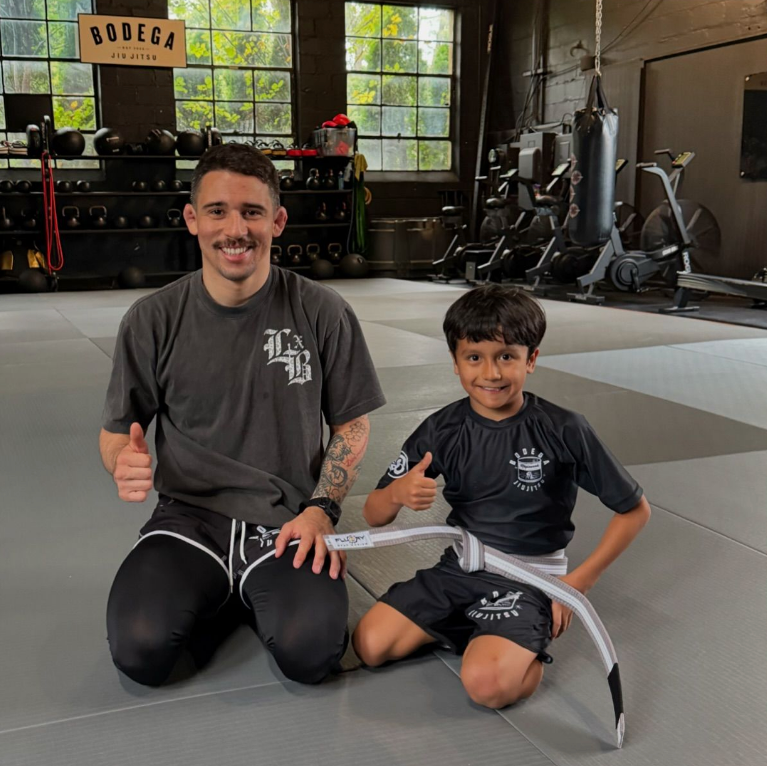 Kids practicing grappling with a coach at Bodega Jiu-Jitsu in Maplewood, NJ, building confidence and teamwork