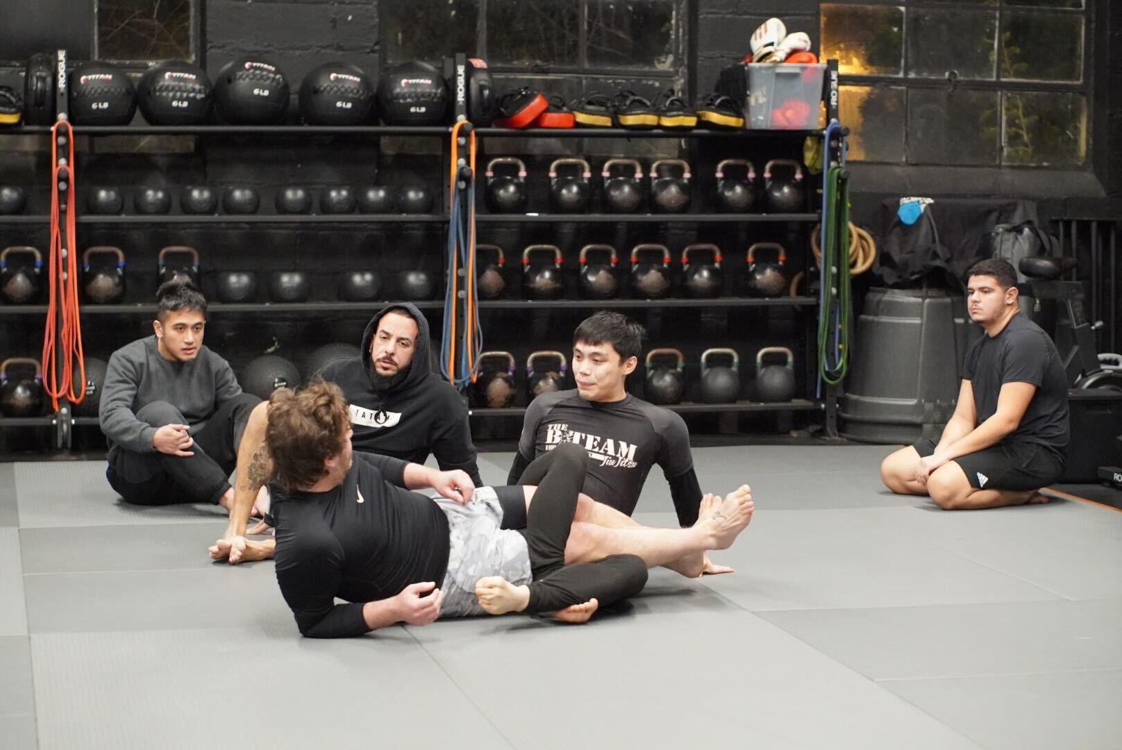 Adults practice grappling drills at Bodega Jiu-Jitsu in Maplewood, NJ, building calm focus and stress relief.