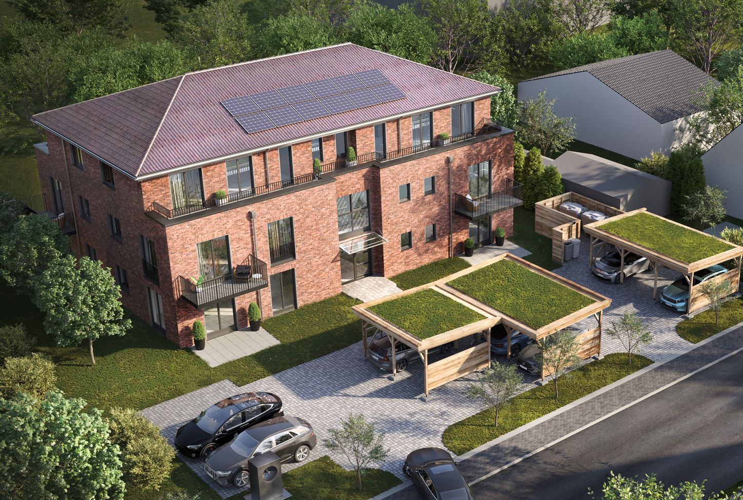 Luftaufnahme eines Backstein-Wohnhauses mit Solaranlagen auf dem Dach und darunterliegenden Parkplätzen.