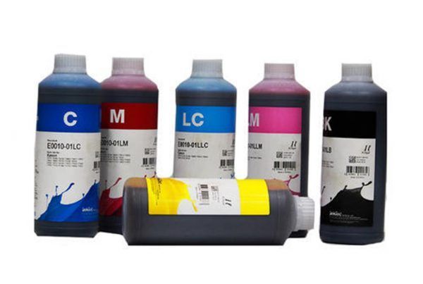 Bottles of ink in various colors: cyan, magenta, light cyan, light magenta, yellow and black for printer use.
