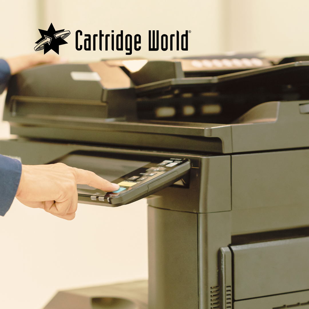 A person using a Cartridge World printer; the control panel is in focus.