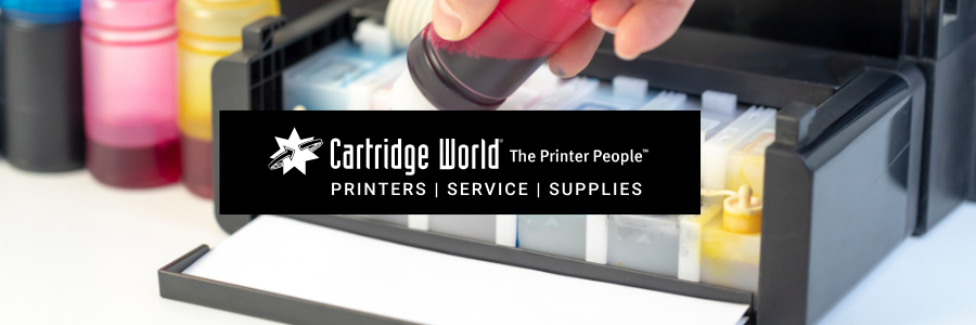 A person refills a printer with red ink from a bottle. The Cartridge World logo is in the center.