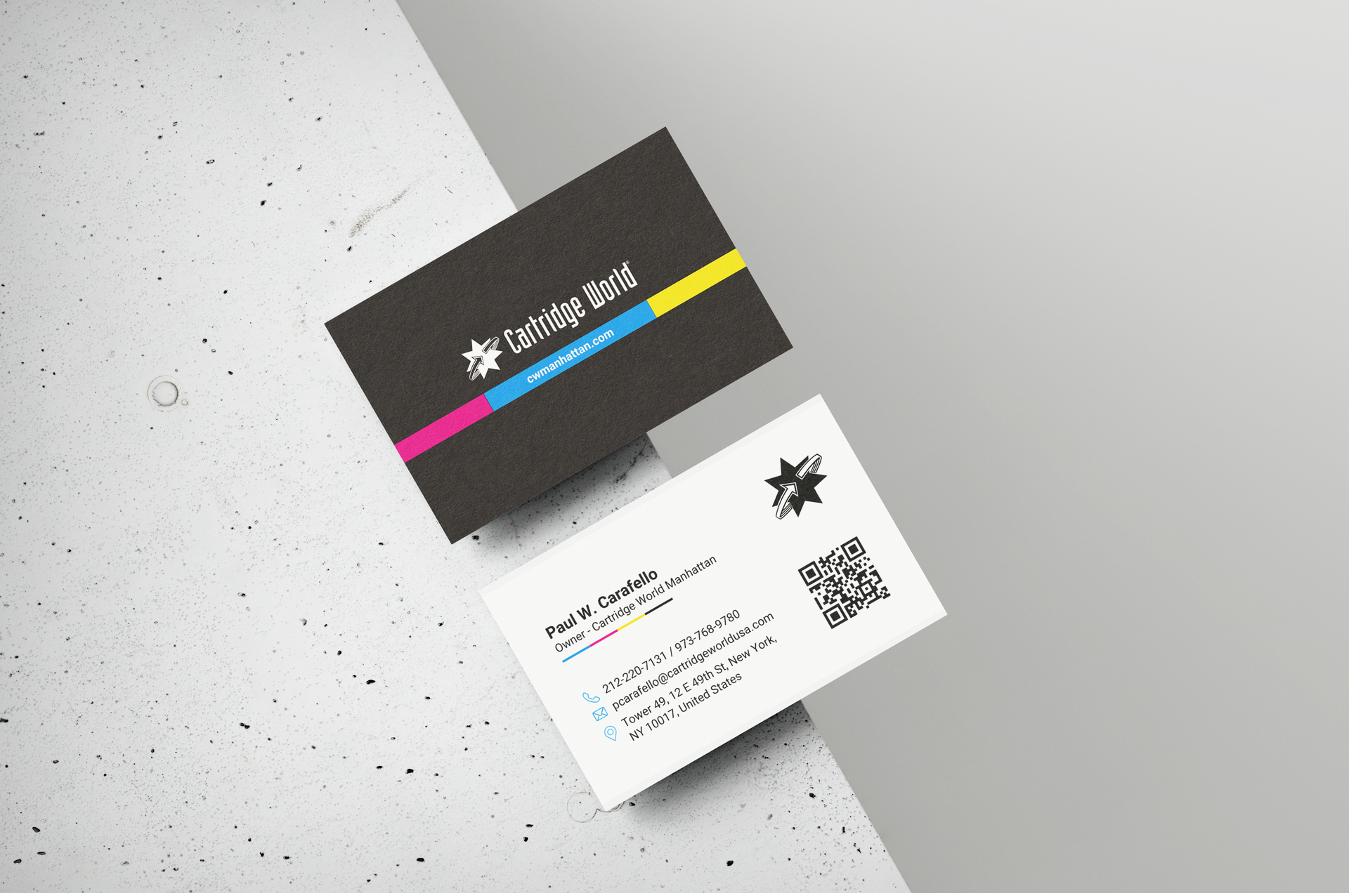 Two business cards, one black with a logo and stripes, the other white with contact information.