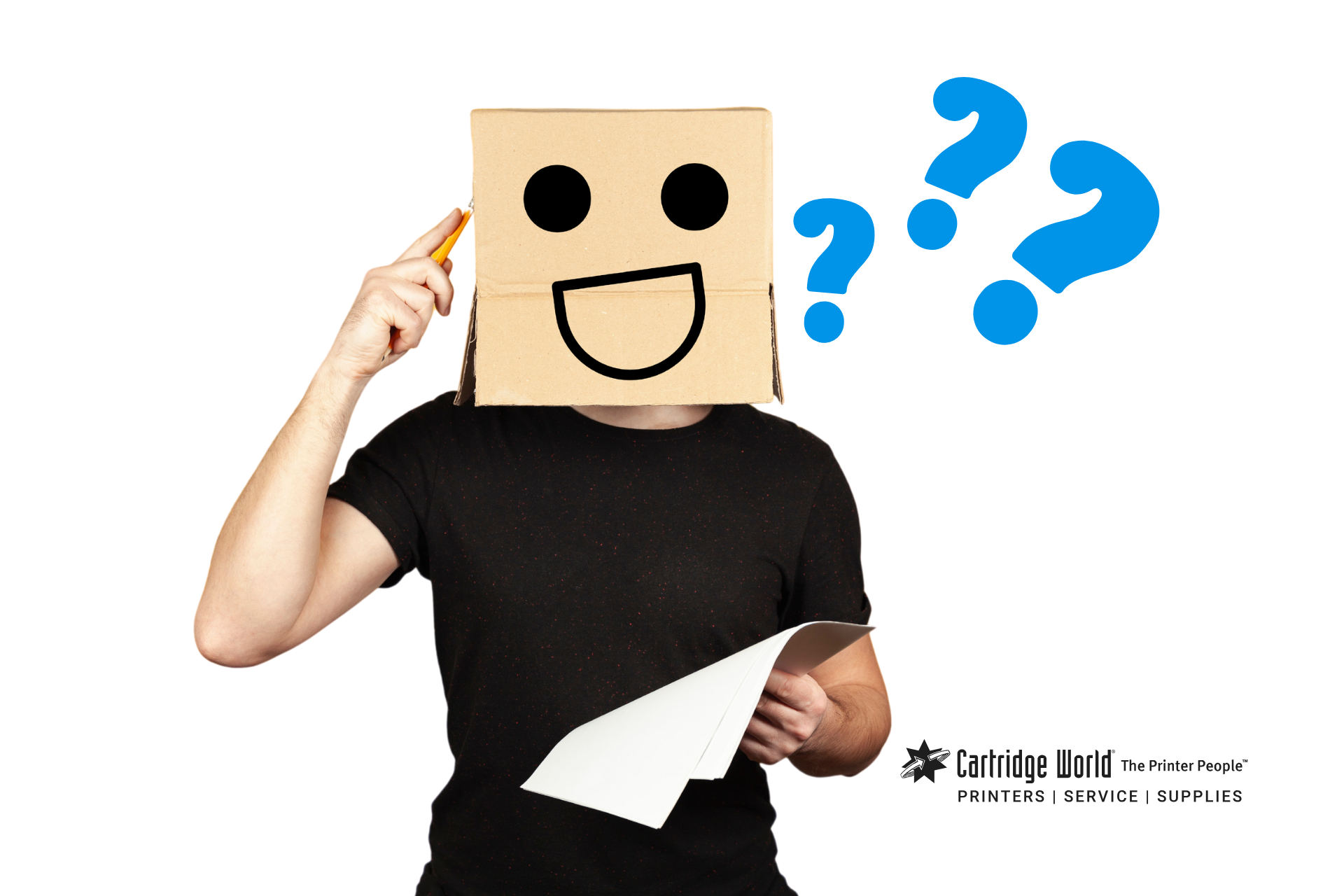 Person with cardboard box head, drawn smiley face, pencil to head, holding paper; question marks.