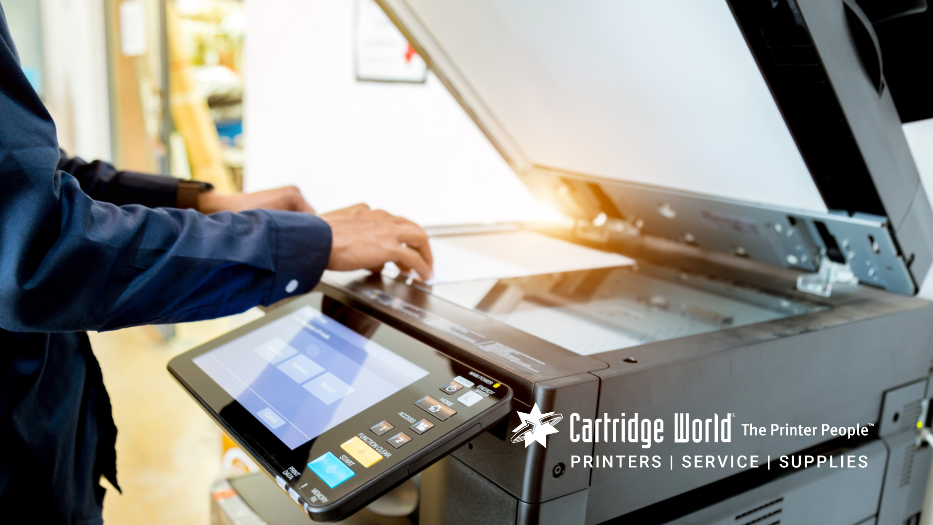 Person using a multifunction printer to copy a document.