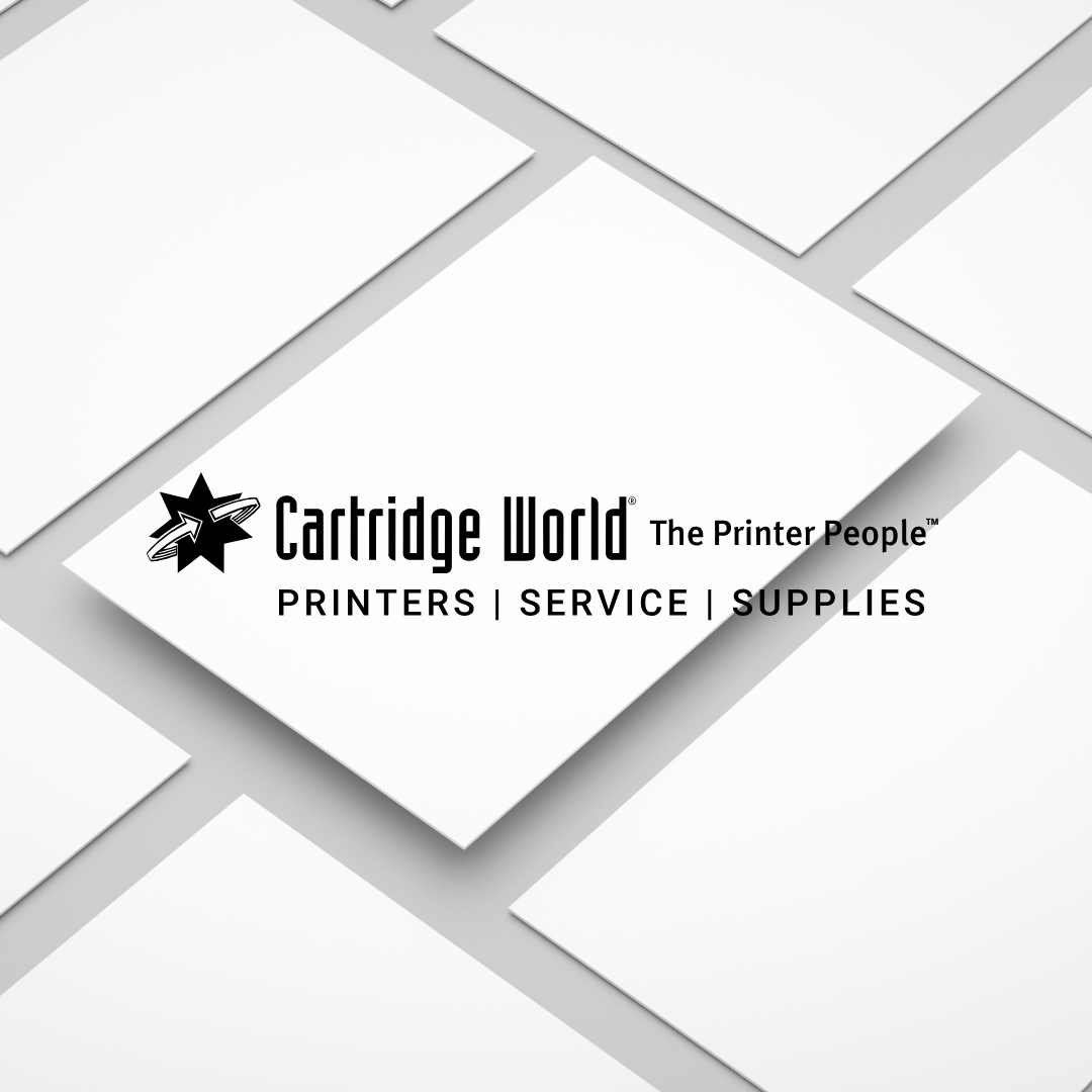 Cartridge World logo on a tilted white card surrounded by other white cards, gray background.