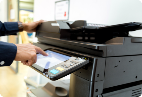 Person using a multifunction printer; touching the screen.