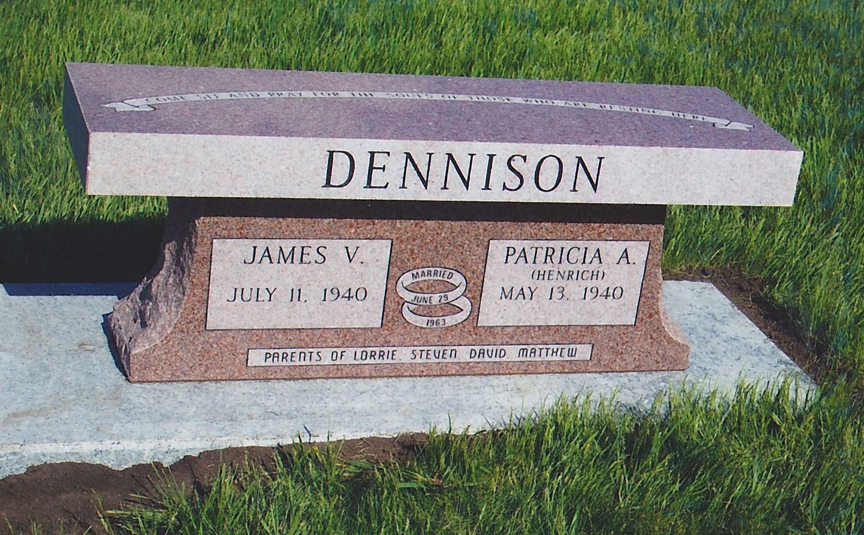 Dennison gravestone in grass with two name plaques and a bench-style top