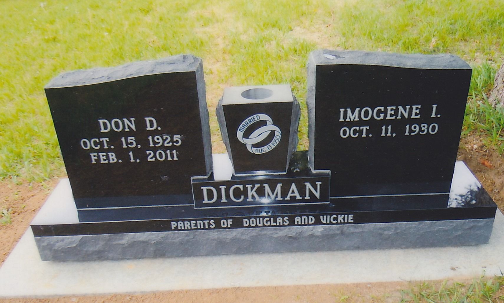 Black granite gravestone with two plaques for Don D. and Imogene I. Dickman, with a rose emblem in the center.