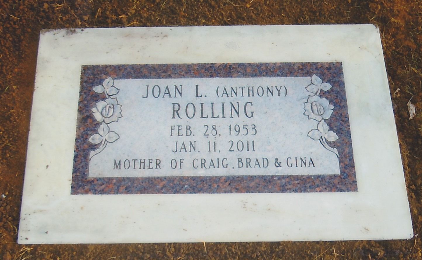 White memorial plaque with purple inscription for Joan L. Rolling, dated Feb. 28, 1953–Jan. 1, 2011.