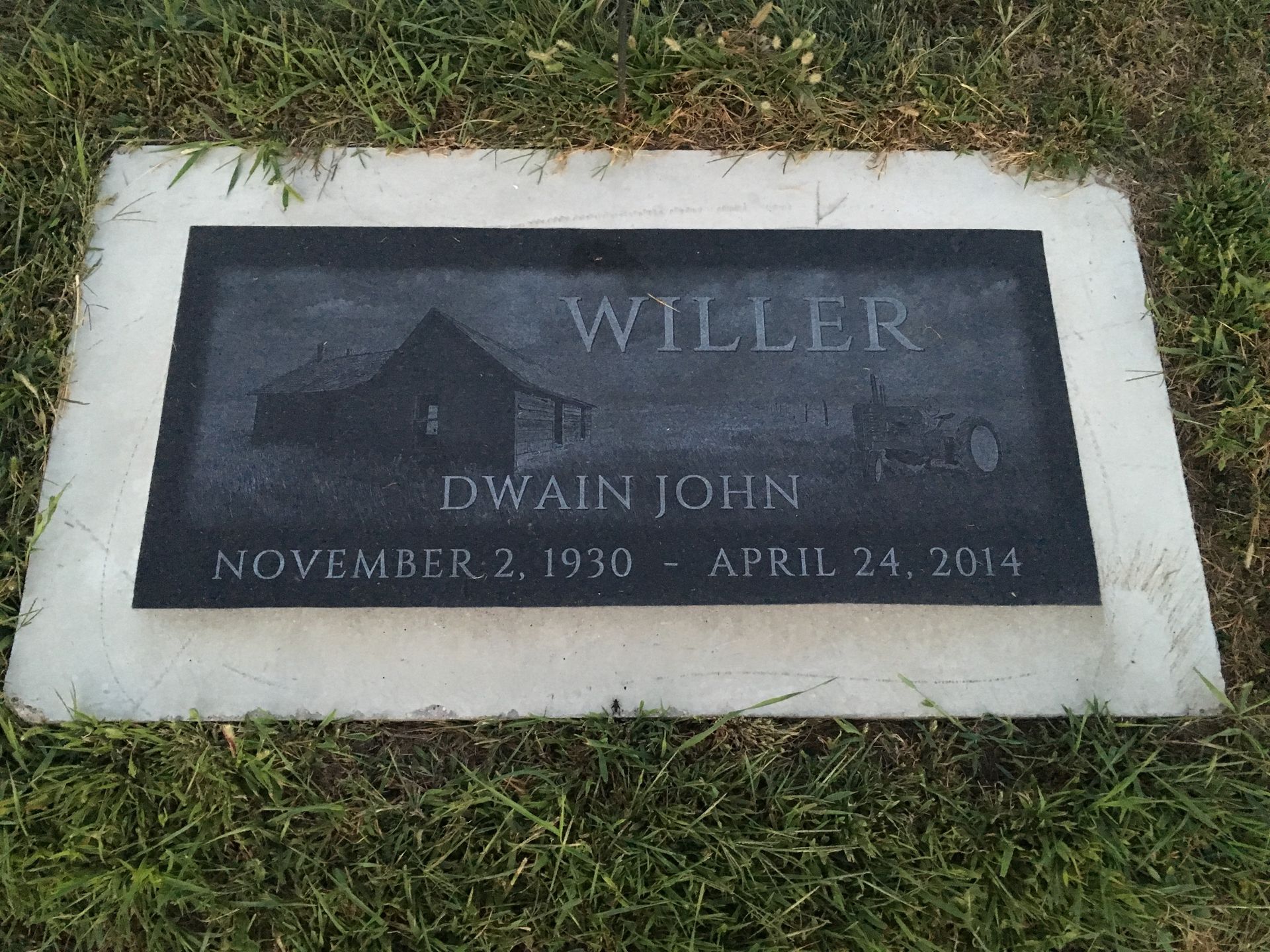 Gravestone plaque on grass with “Willer” and “Dwain Joni,” dated November 2, 1930–April 24, 2014
