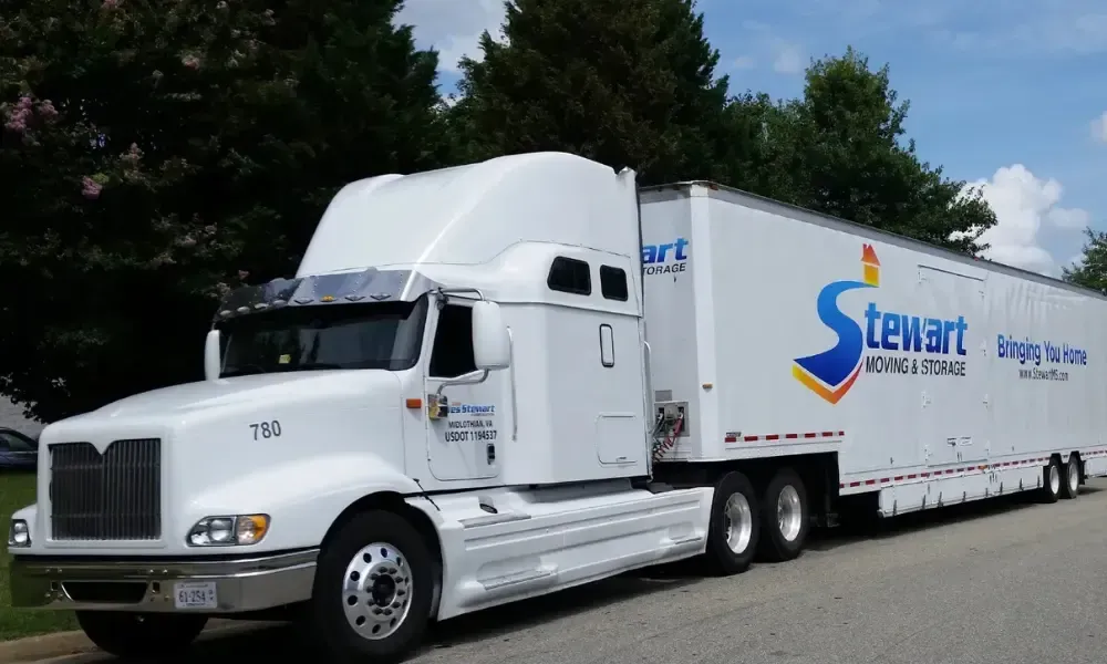 A white semi truck with the words Stewart Moving & Storage on the side