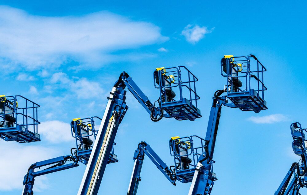 A Group of Blue Aerial Lifts Against a Blue Sky — FNQ Hot Water In Mareeba, QLD