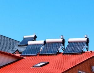There Are Three Solar Panels on the Roof of a House — FNQ Hot Water In Mareeba, QLD