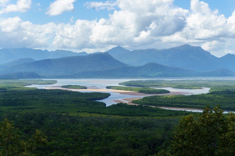 A Large Body of Water Surrounded by Mountains and Trees — FNQ Hot Water In Atherton, QLD