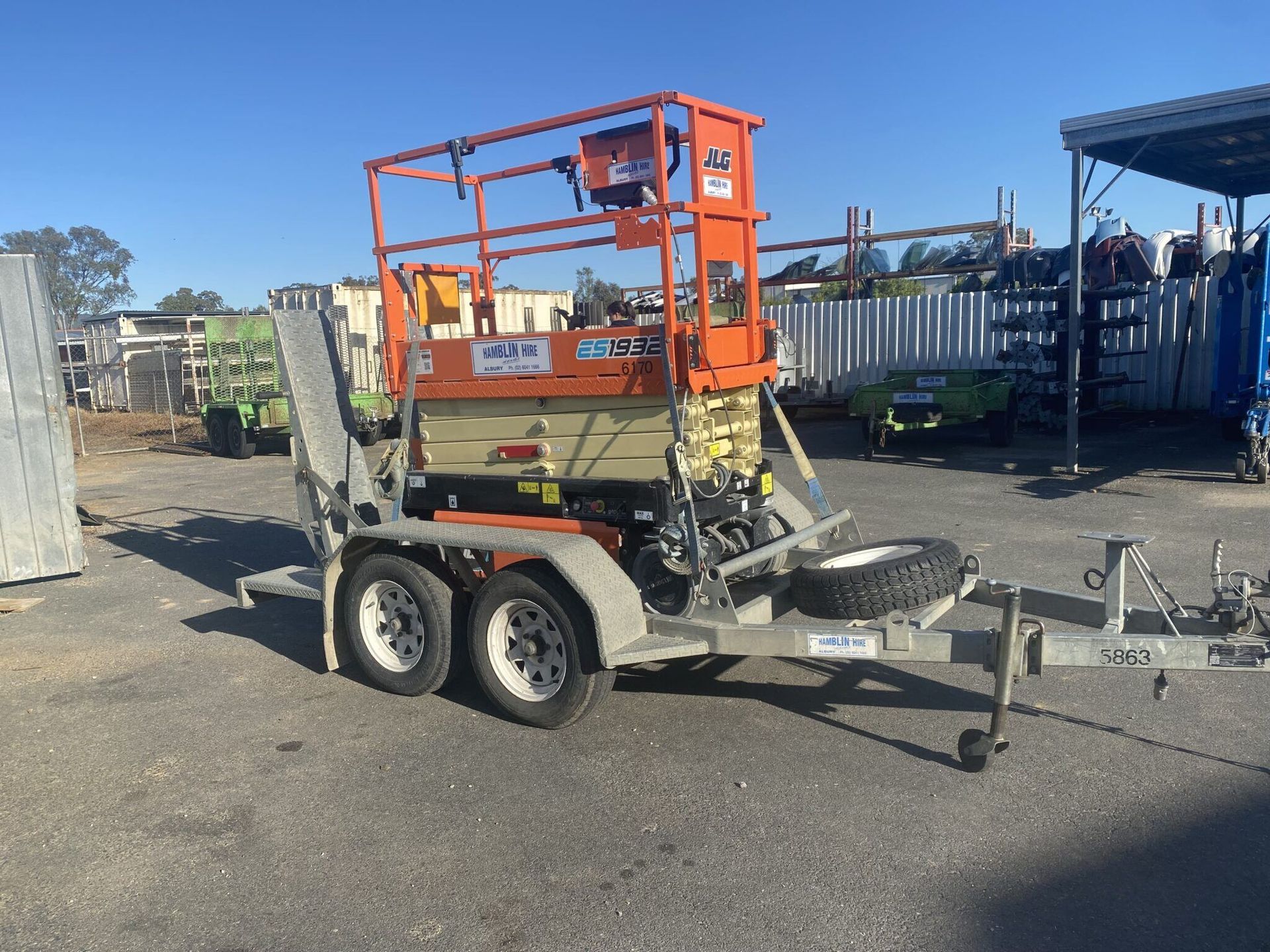A Trailer With a Lift on It is Parked in a Parking Lot — FNQ Hot Water In Mareeba, QLD