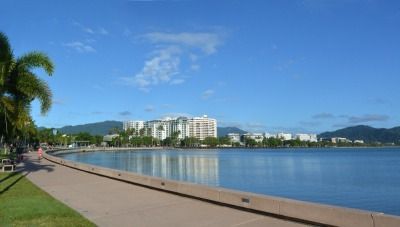 A Walkway Along a Body of Water With a City in the Background — FNQ Hot Water In Cairns, QLD