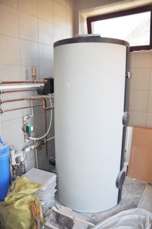 A Large White Water Heater is Sitting in a Room Next to a Window — FNQ Hot Water In Atherton, QLD