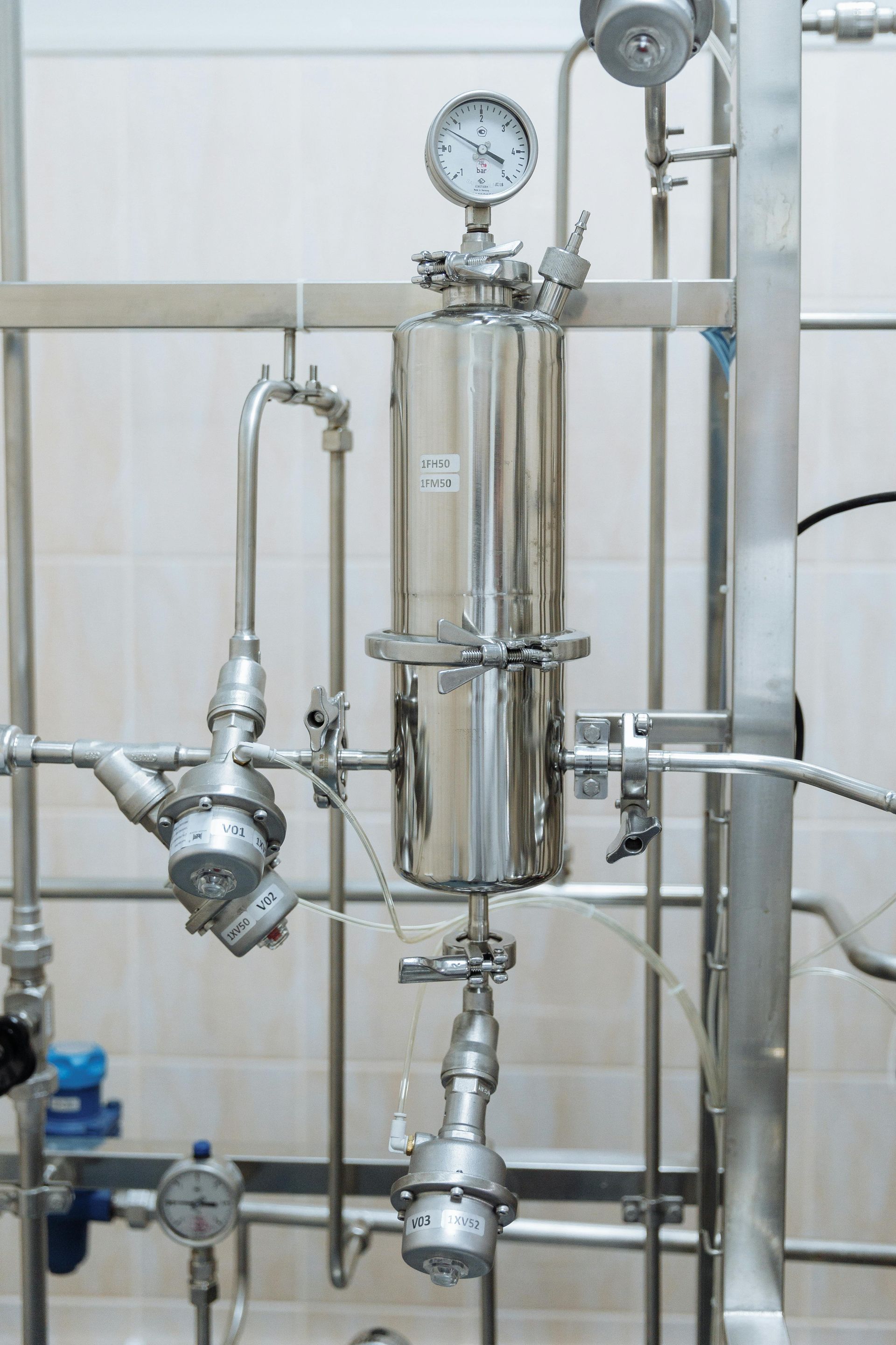 A Stainless Steel Pipe With a Clock on Top of It — FNQ Hot Water In Mareeba, QLD
