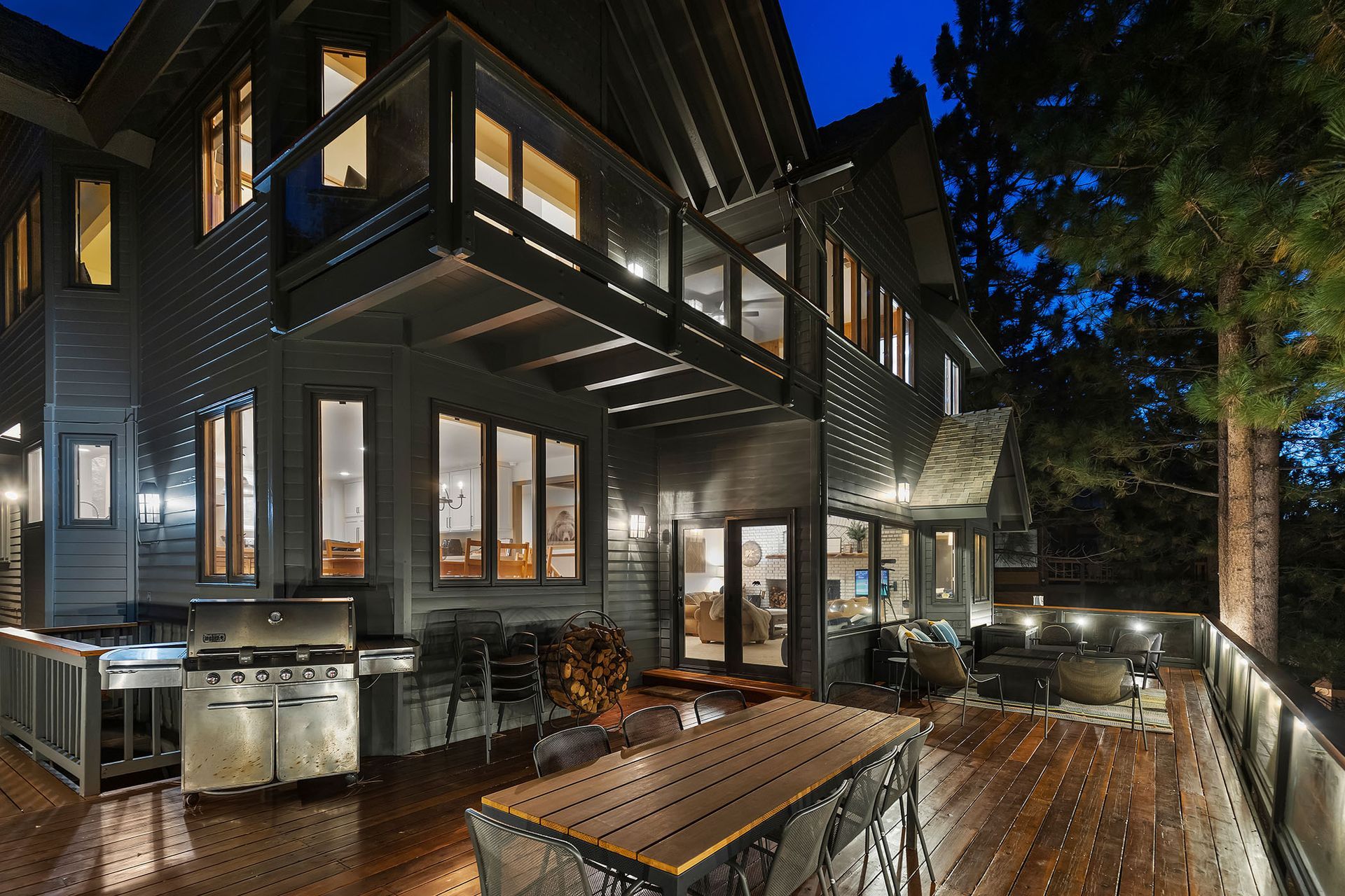 A large house with a large deck and a grill