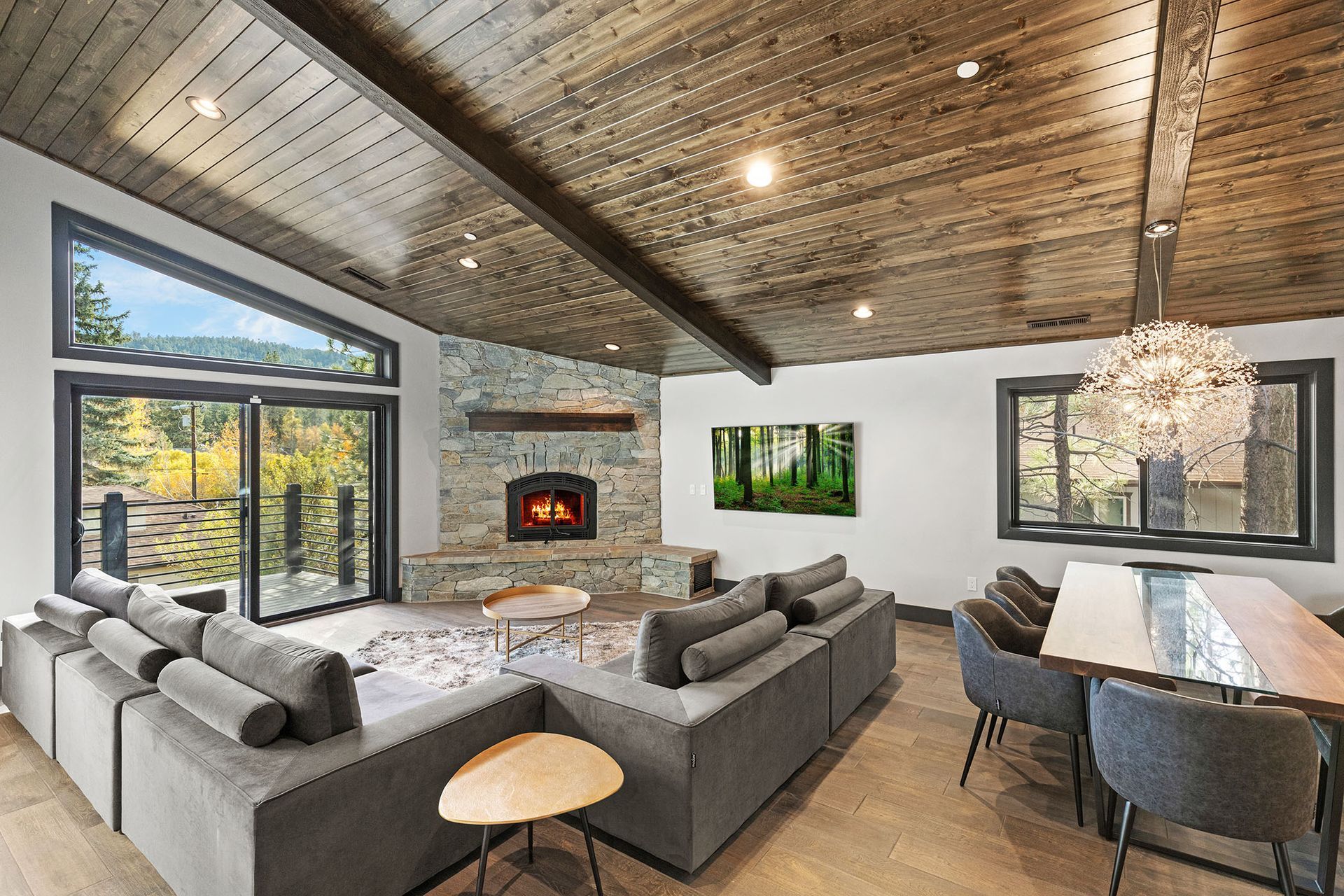 A living room with a couch , table , chairs and a fireplace.