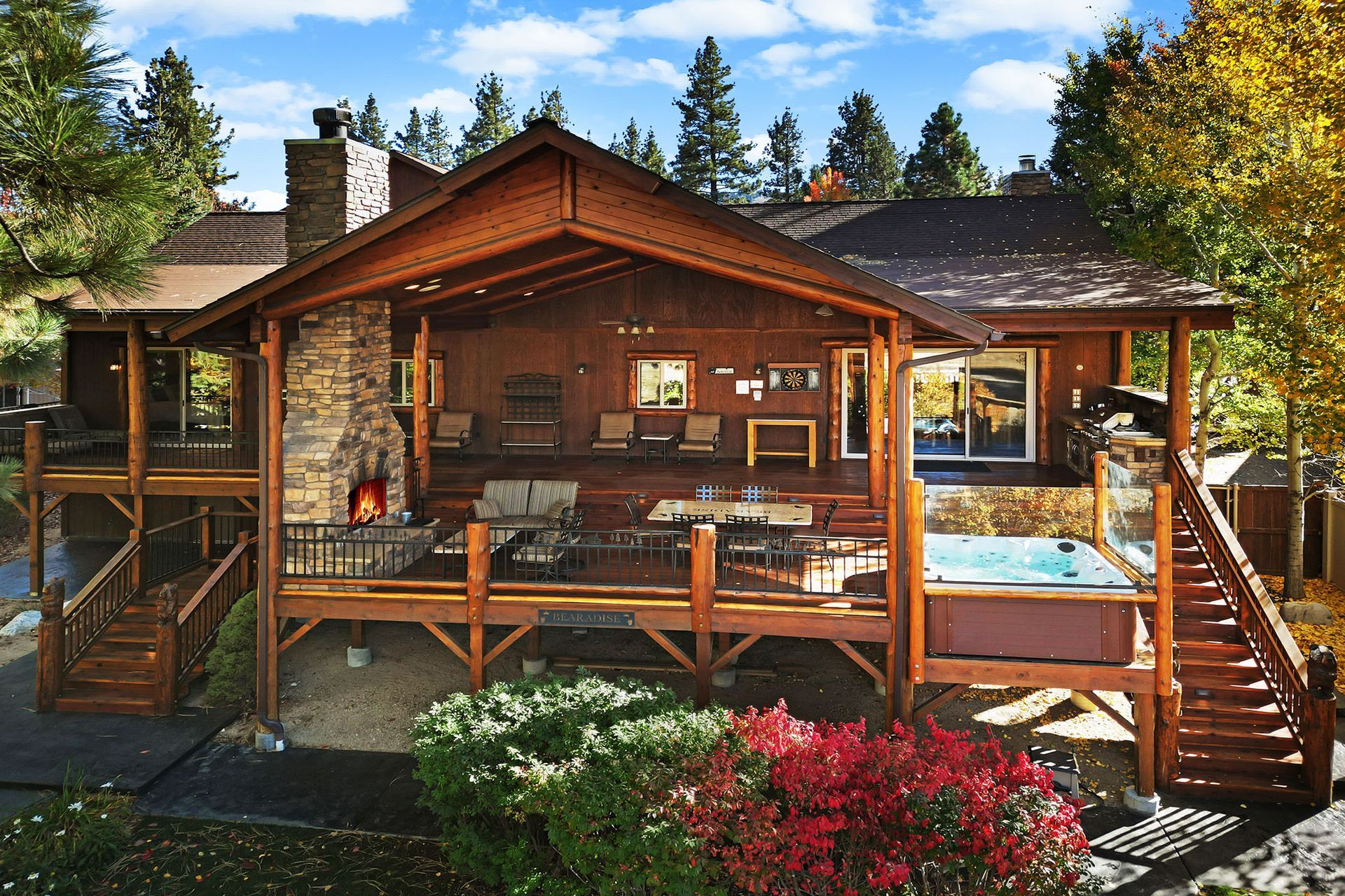 A large wooden house with a hot tub on the deck