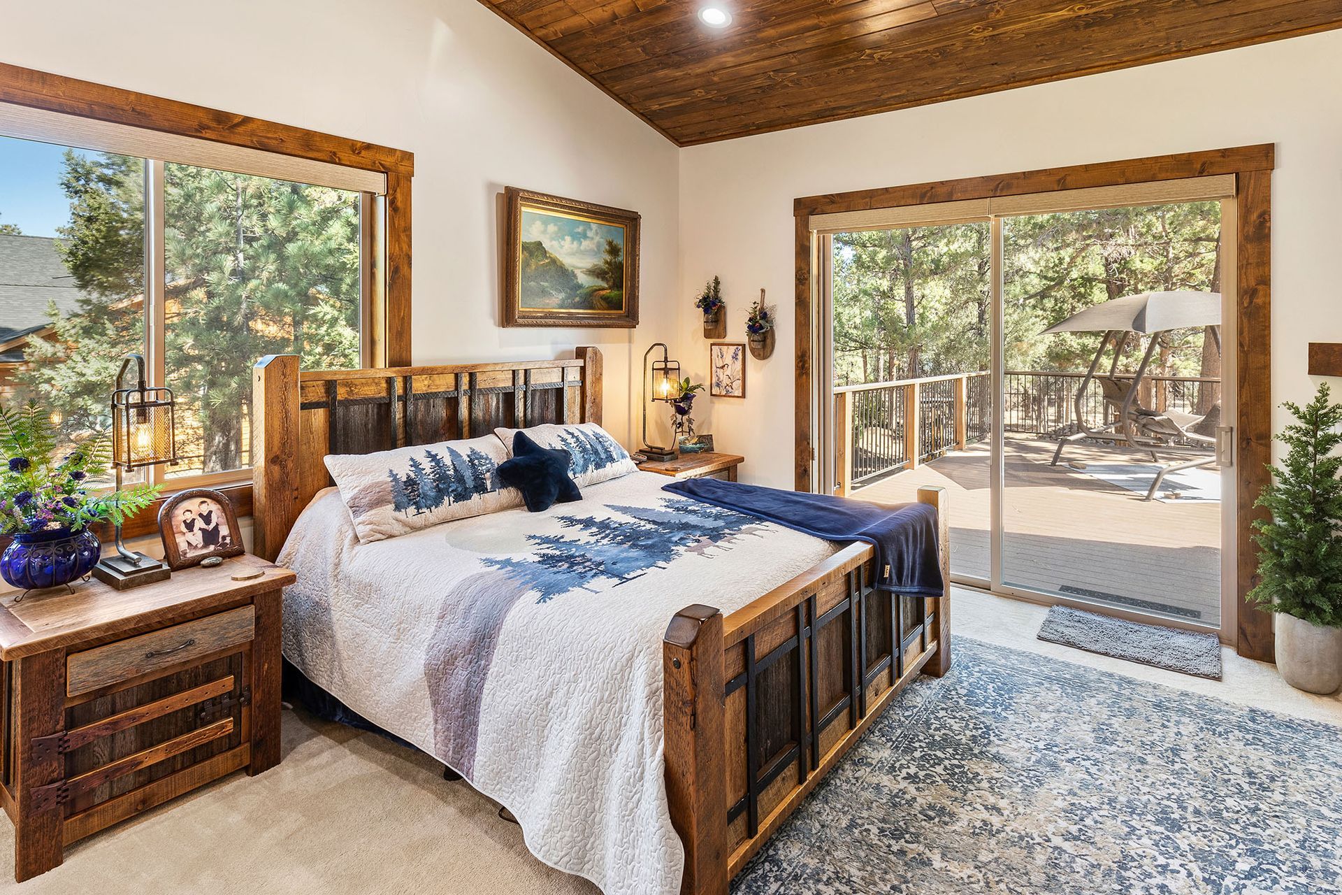 A bedroom with a bed , nightstand , and sliding glass doors.