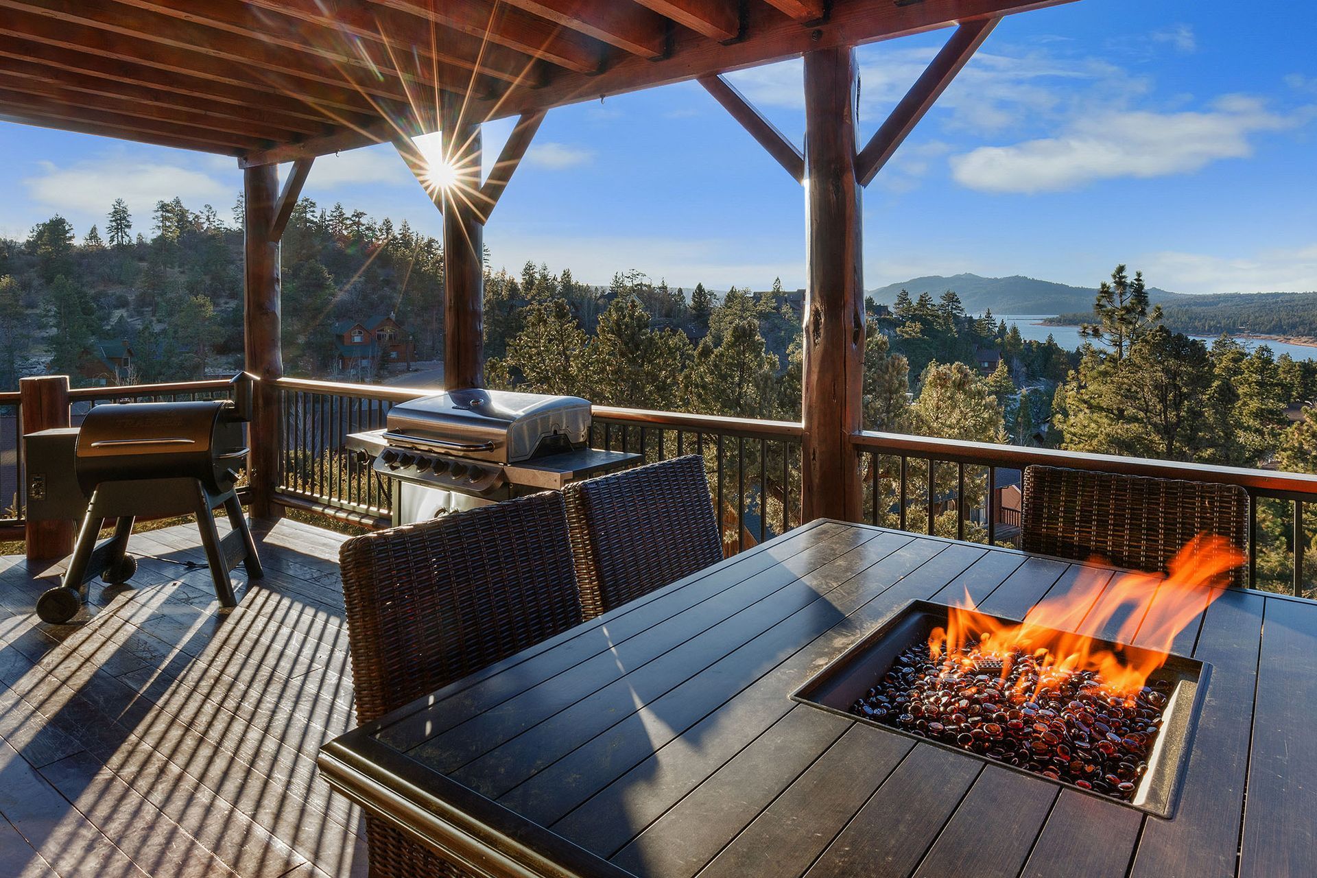 A deck with a table and chairs and a fire pit