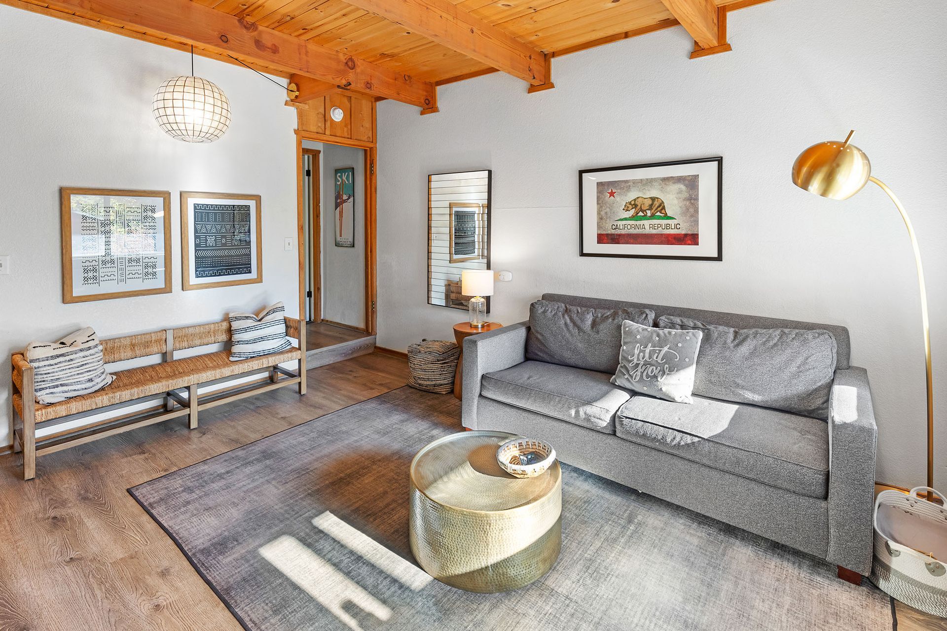 A living room with a couch , coffee table and bench.