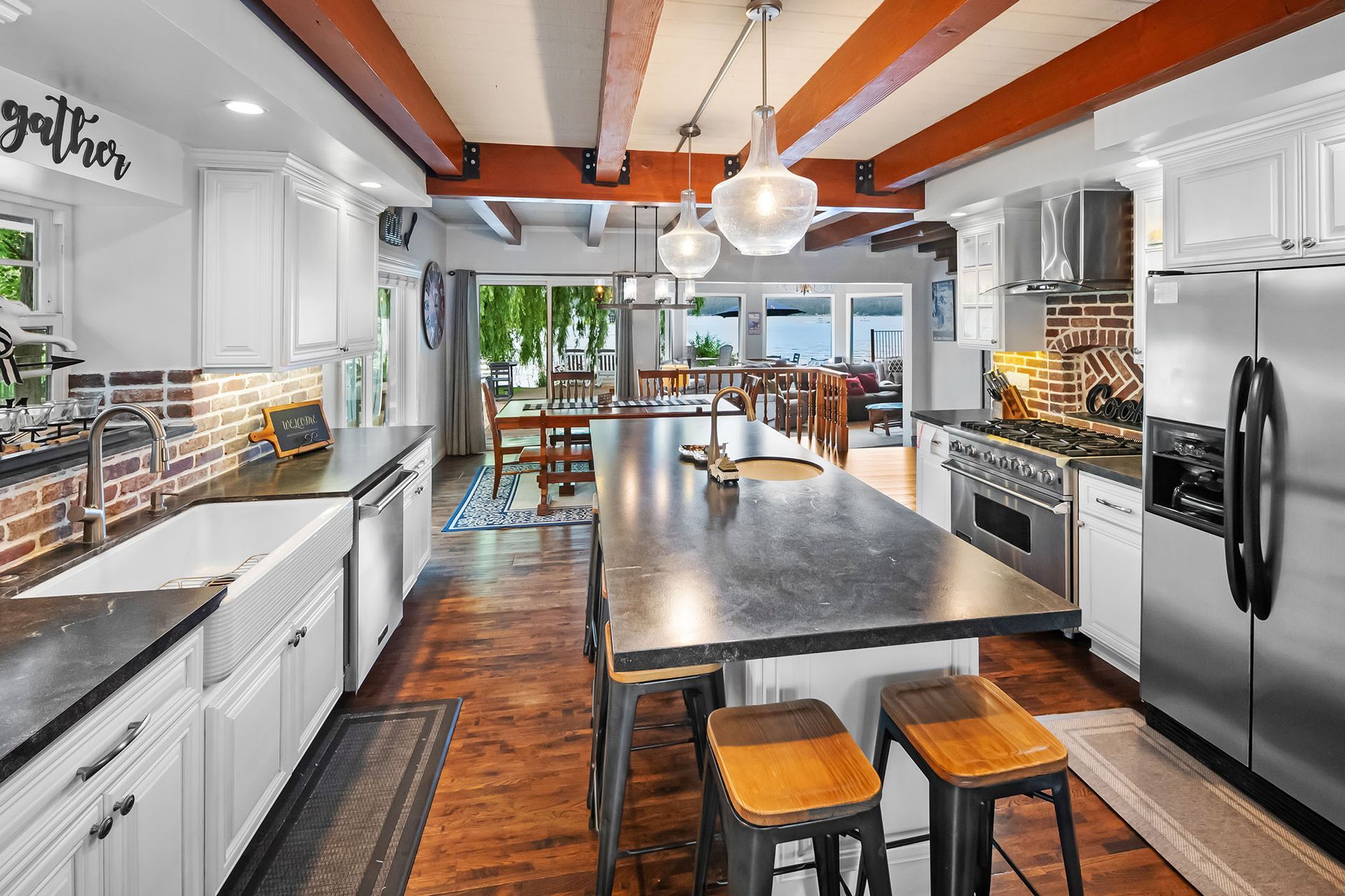 A kitchen with stainless steel appliances and a large island.