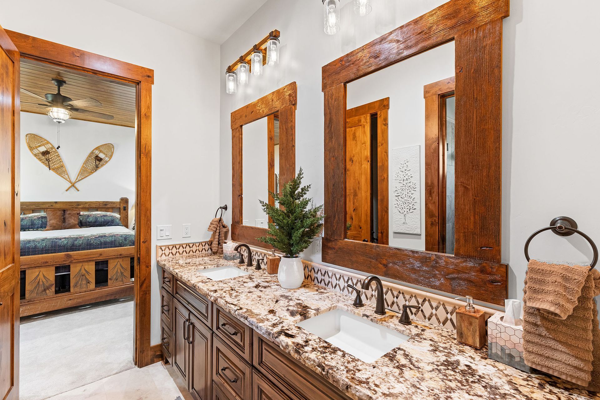 A bathroom with two sinks and two mirrors.