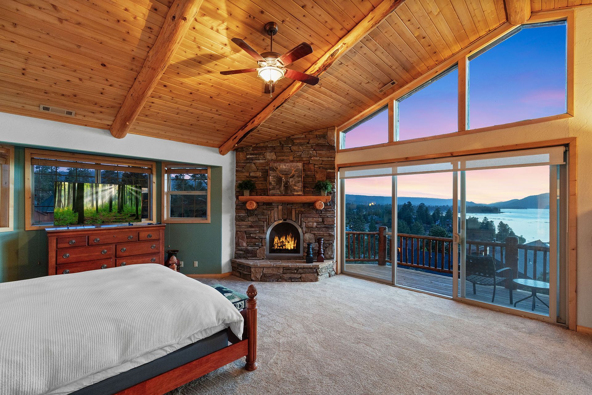 A bedroom with a fireplace and sliding glass doors