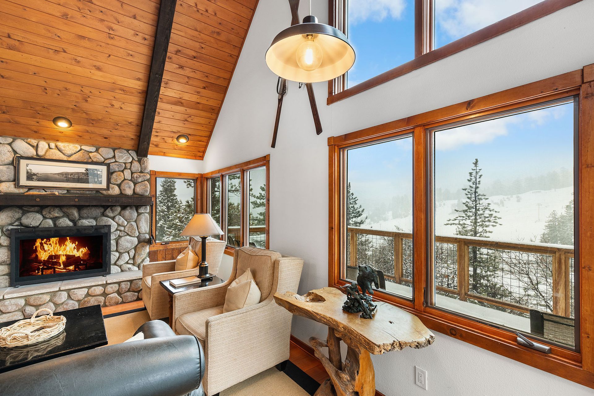 A living room with a fireplace and lots of windows