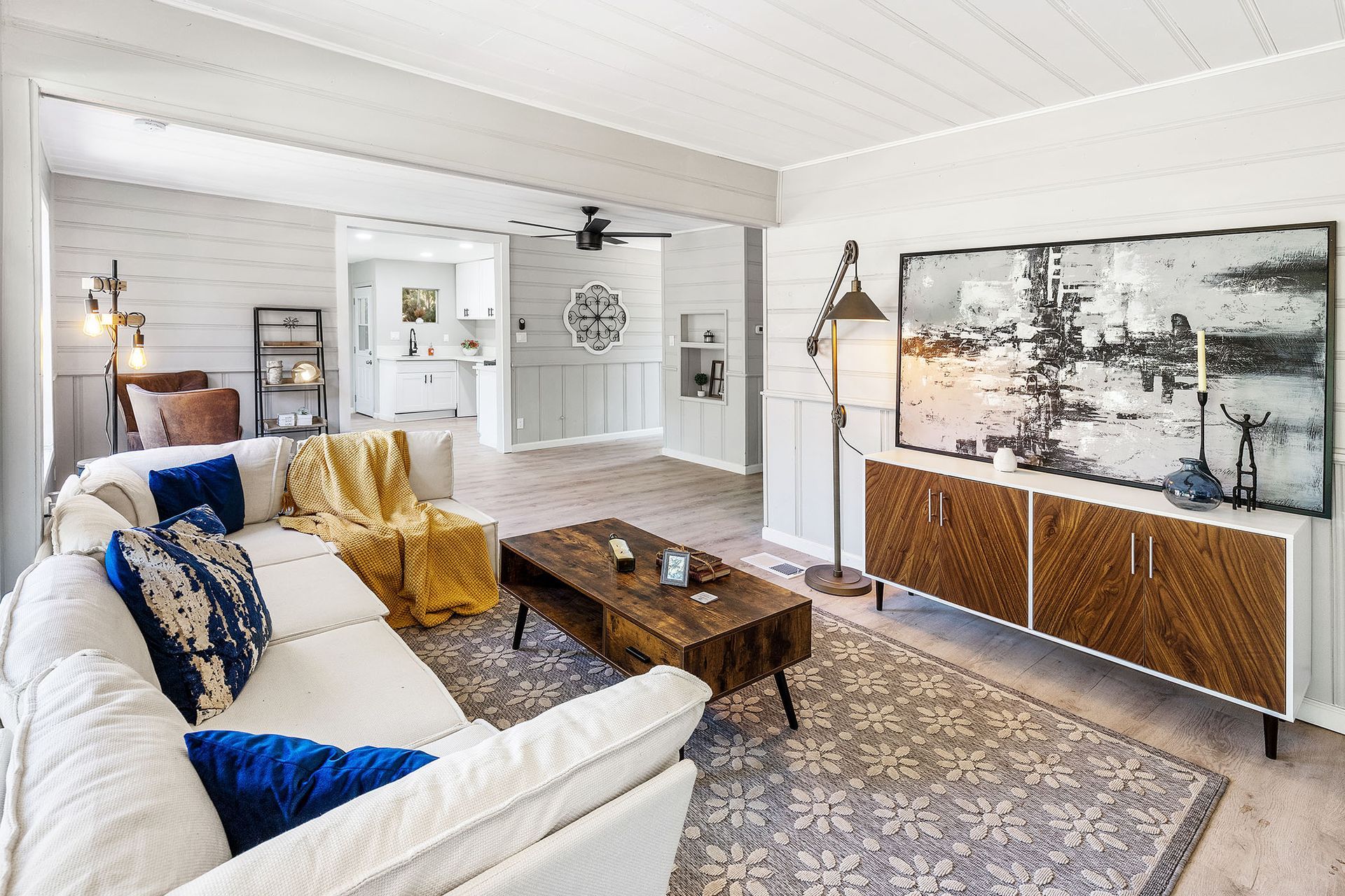 A living room with a couch , coffee table , and television.