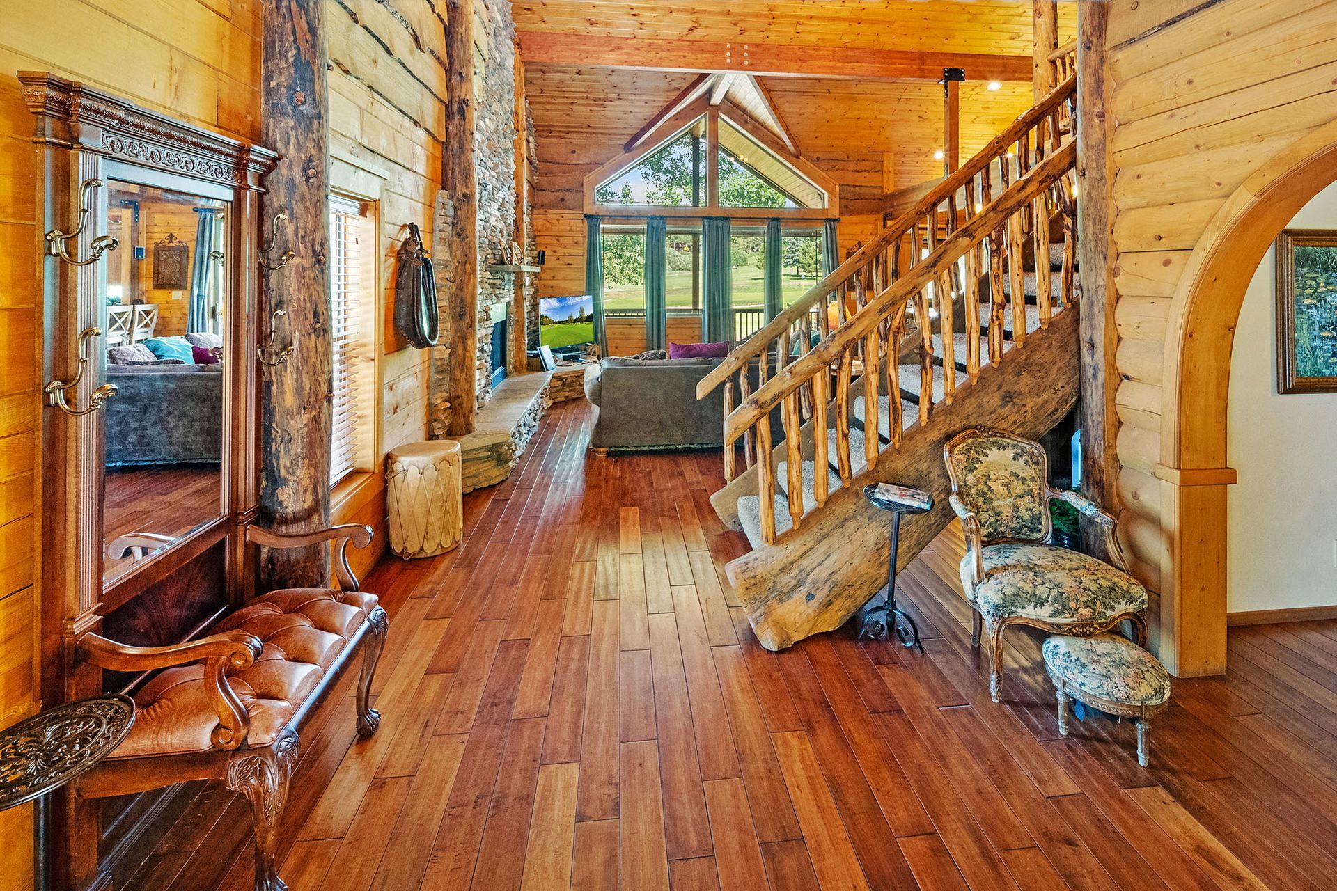 A large wooden house with a staircase leading up to the second floor.
