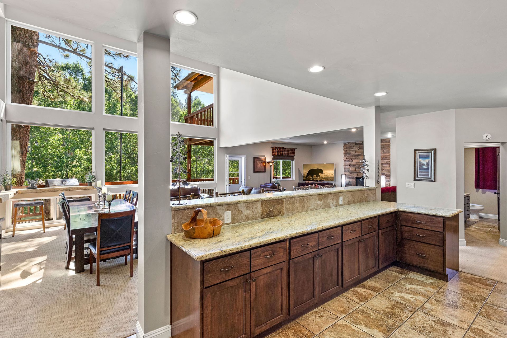 A kitchen with wooden cabinets and granite counter tops in a house.