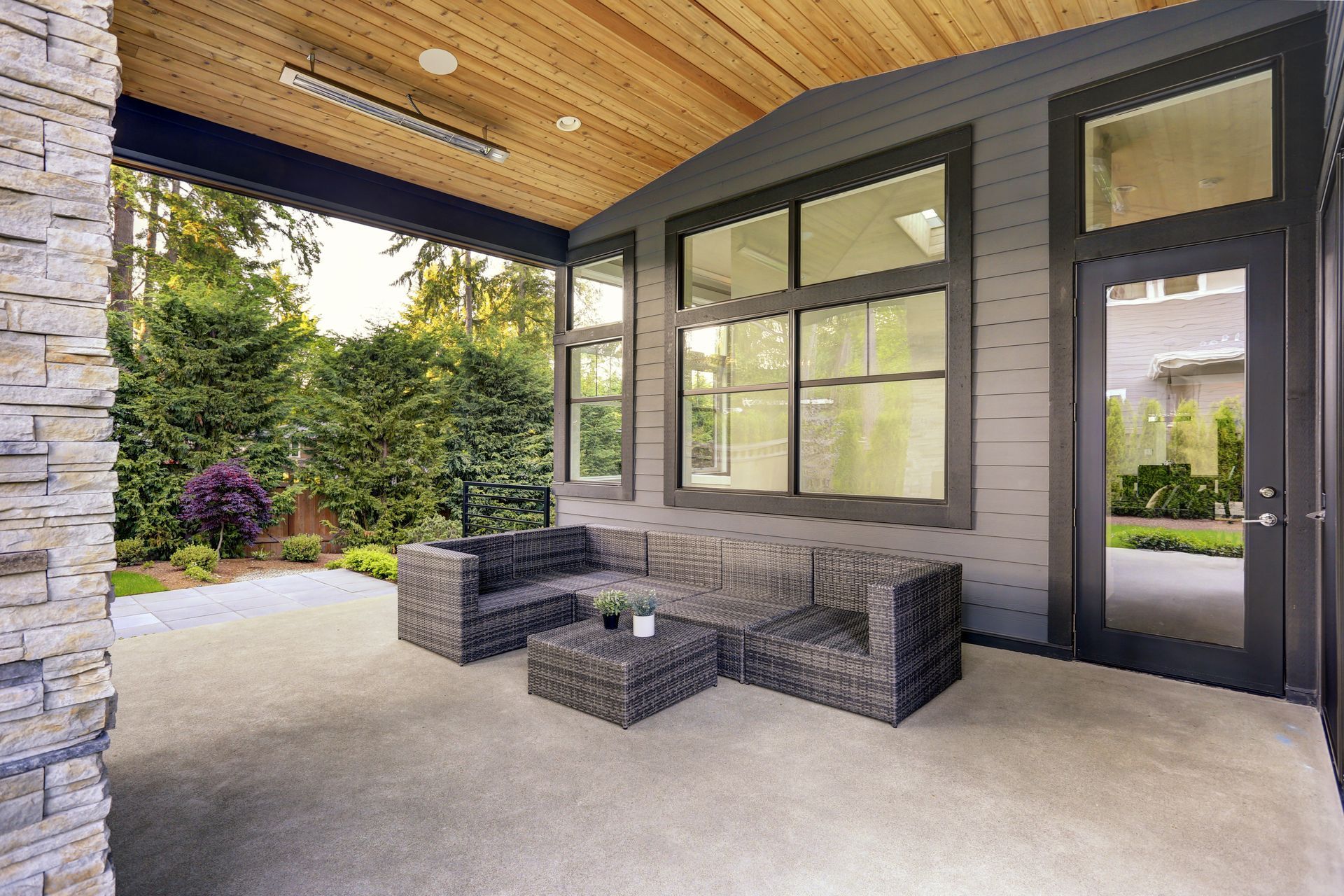 A patio with a couch , chairs , and a table.