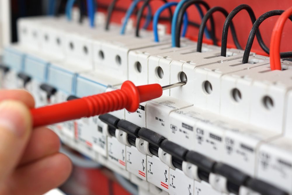 A Person Is Using A Multimeter To Test A Circuit Breaker — Keany's Electrical Service In North Nowra, NSW