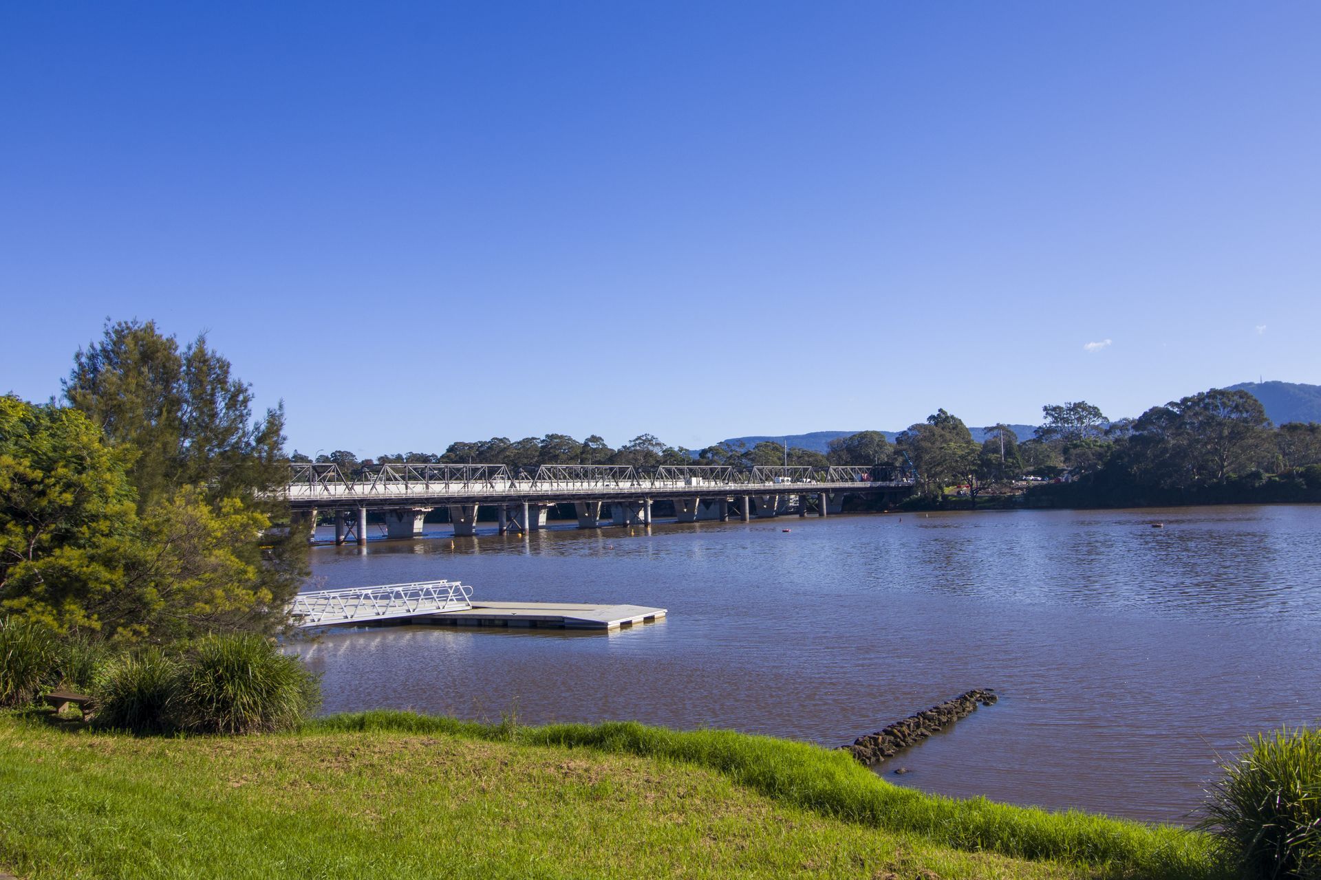 A Bridge Over A Body Of Water With A Dock In The Foreground — Keany's Electrical Service In South Nowra, NSW