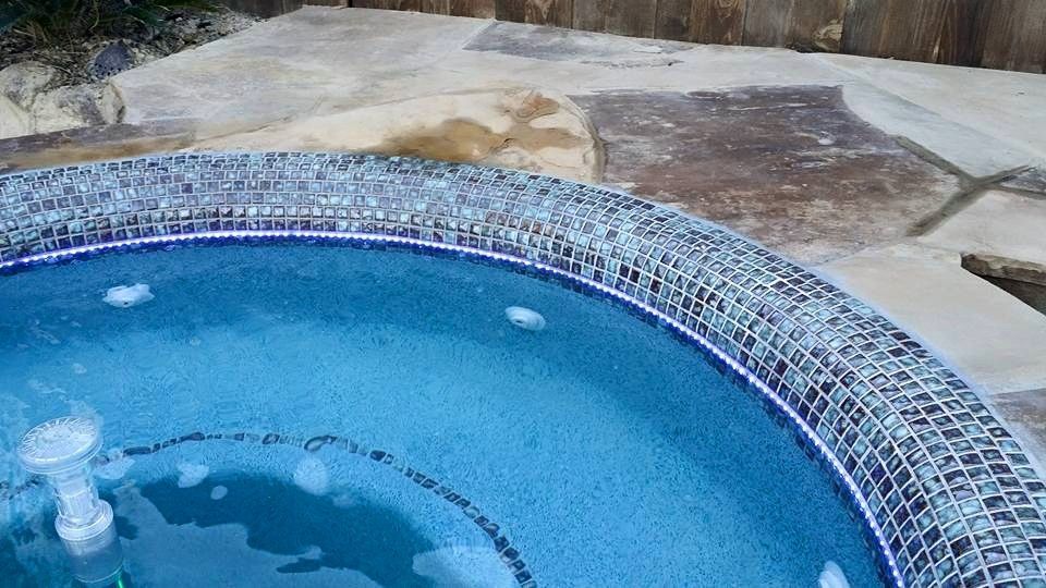 A blue hot tub with bubbles coming out of it