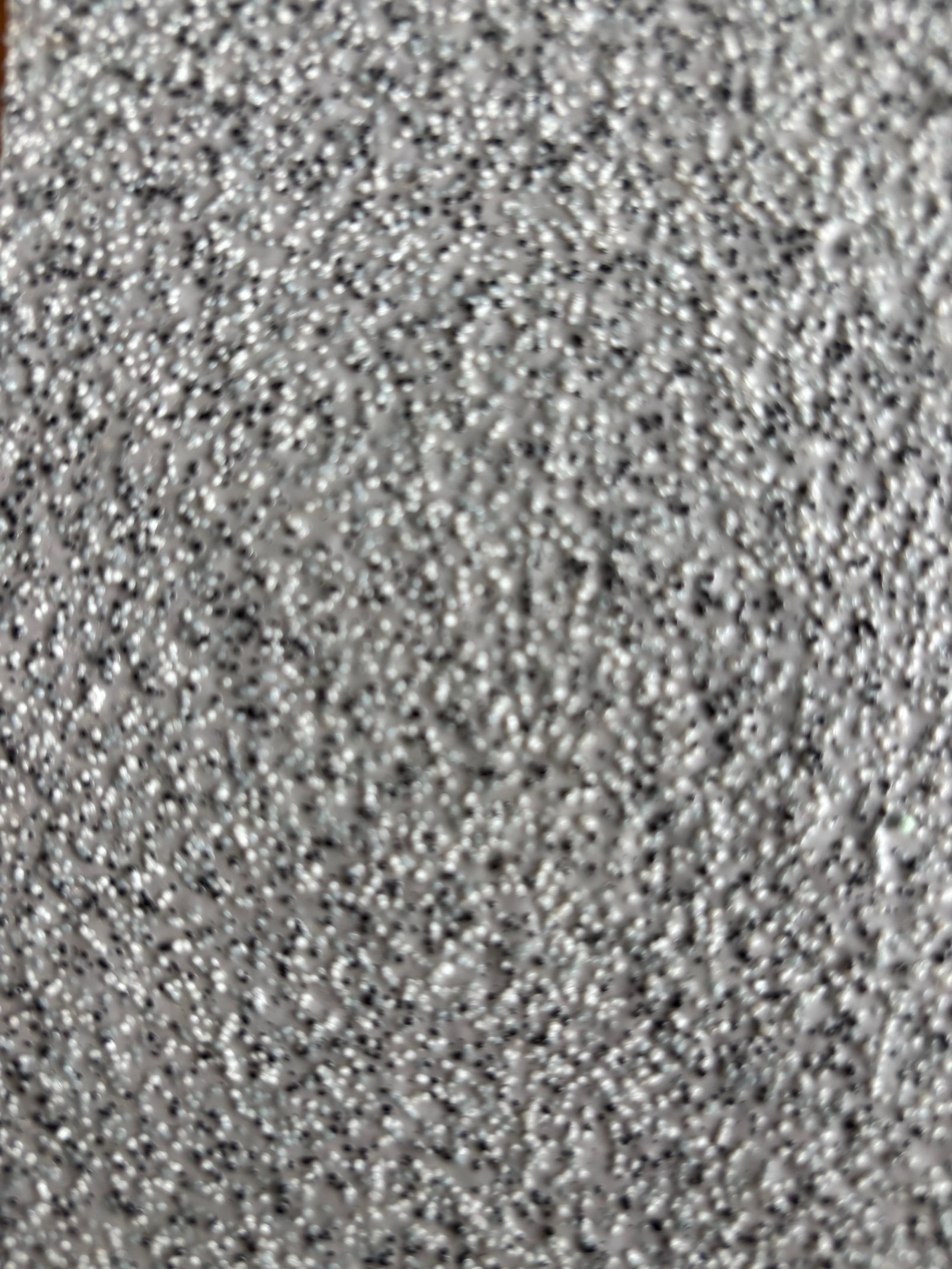 Texture de tapis gris moucheté.