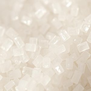 Close-up of translucent white sugar crystals piled together