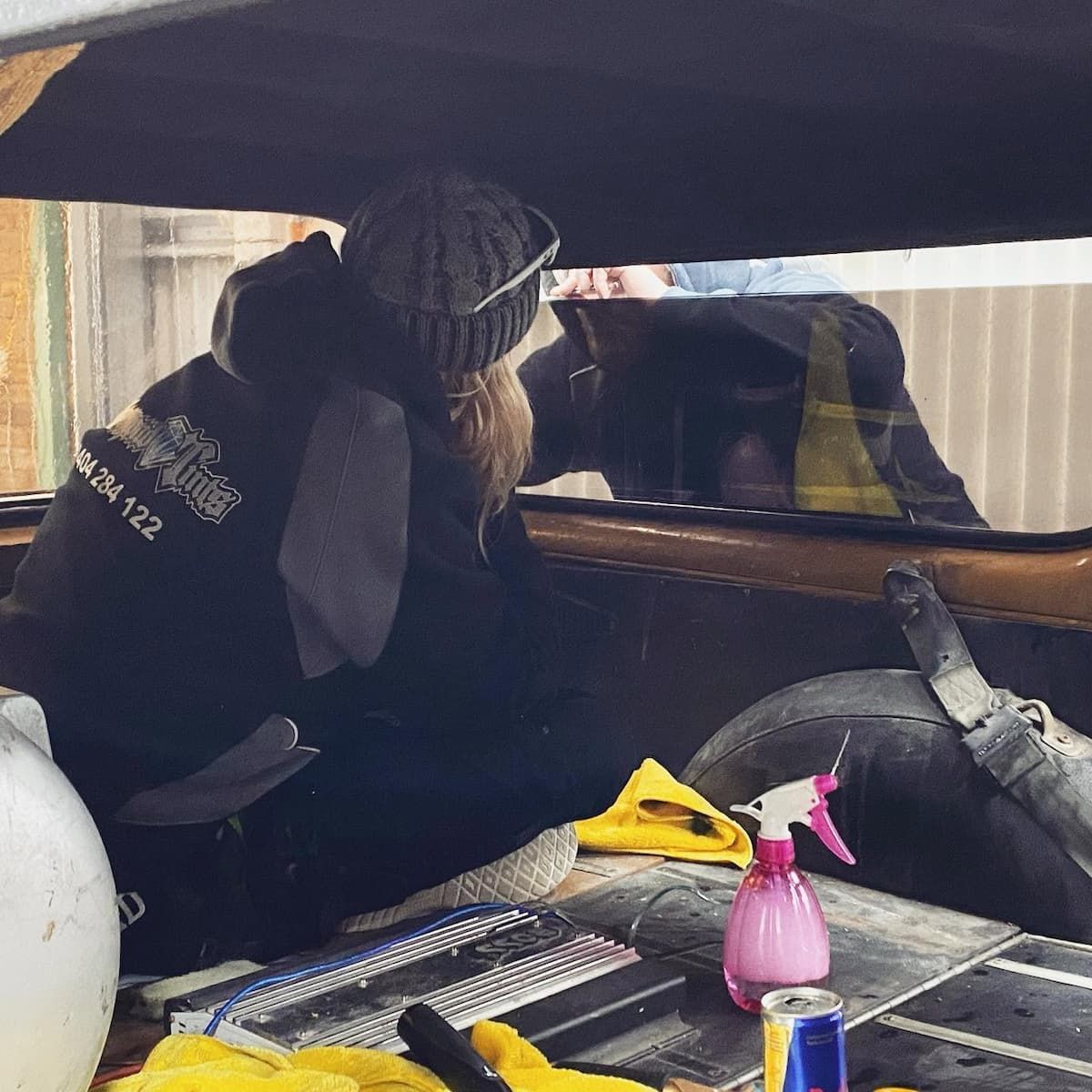 Person Leaning Into a Car Trunk, Cleaning the Interior — Diamond Window Tints in Phillip, ACT
