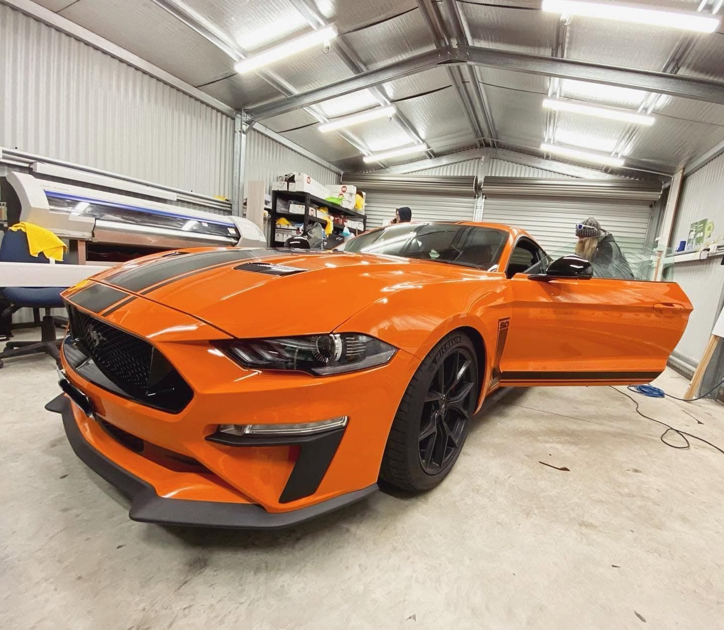 Orange Sports Car in A Garage with The Driver’s Door Open, Low Angle View — Diamond Window Tints in Phillip, ACT